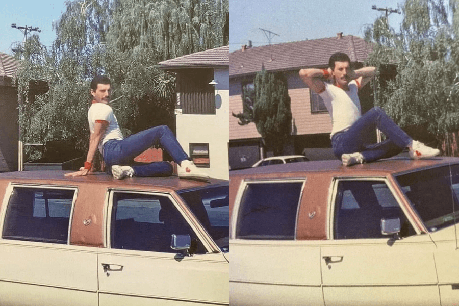 Side-by-side photos of Freddie Mercury striking playful poses on the roof of a vintage cream and tan Cadillac. Dressed in a fitted white t-shirt with red trim, blue pants, and white sneakers, he lounges and stretches under sunny skies in a suburban neighborhood with trees and mid-century houses in the background.