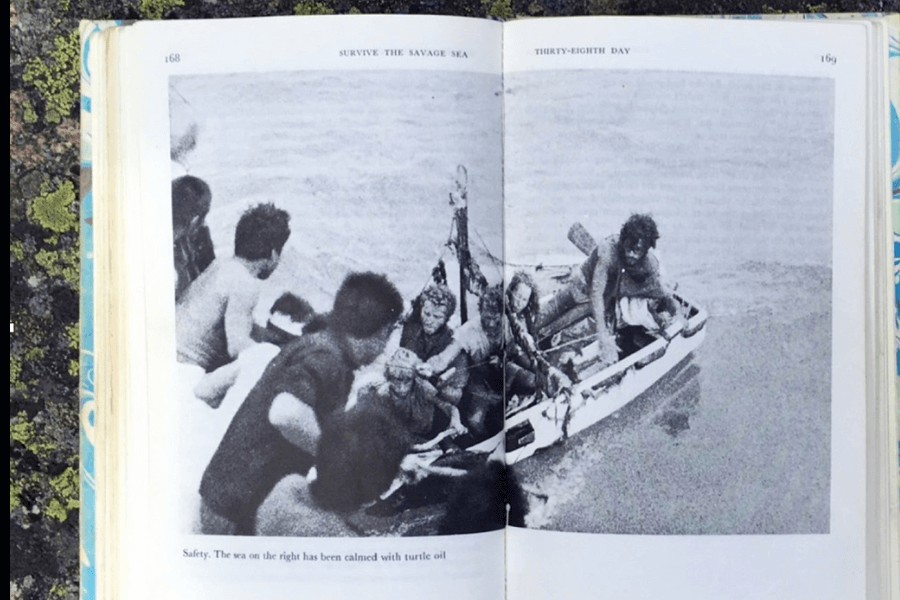 Photograph from the book Survive the Savage Sea showing a dramatic moment on the thirty-eighth day of survival. A group of castaways in a small, crowded lifeboat are approached by rescuers leaning over from a larger vessel. The sea on the right appears unusually calm, as noted in the caption, due to being treated with turtle oil.