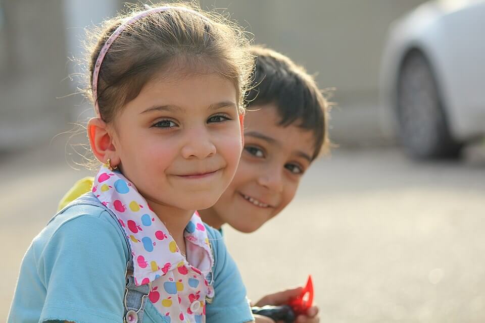 Smiling young boy and girl looking at the camera