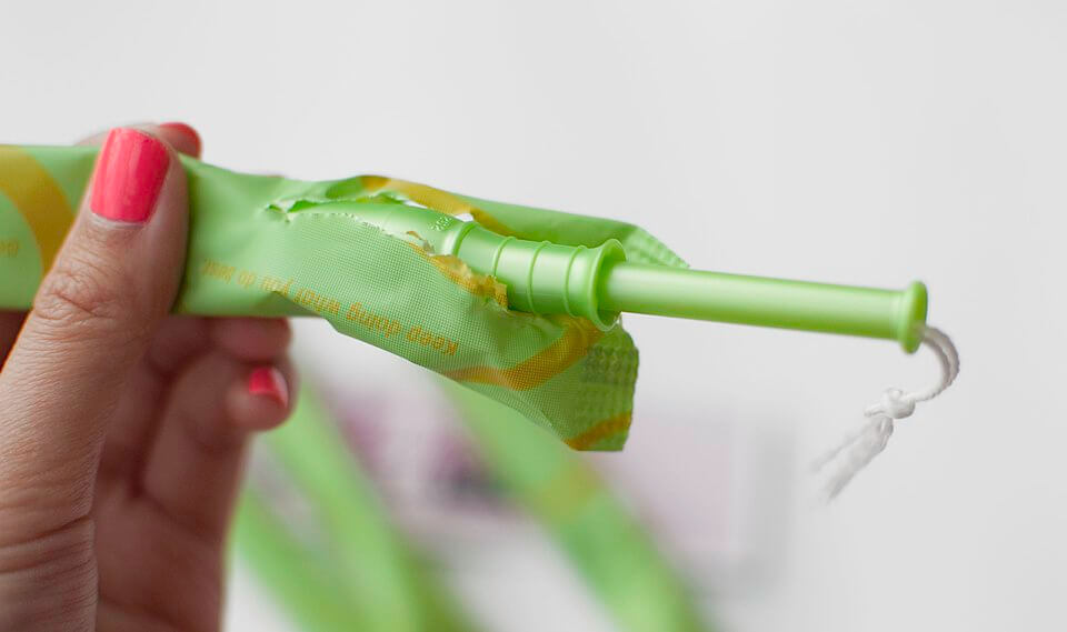 Tampon. Period product inside a green, plastic paper.