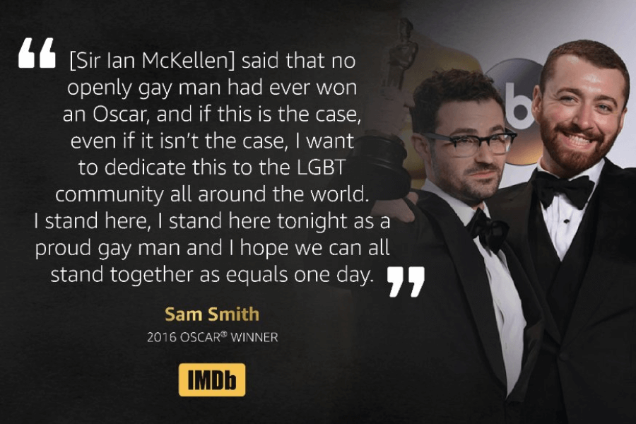 : Sam Smith and a companion pose at the Oscars, both wearing tuxedos and smiling, with Sam holding up an Oscar statue. To the left is a quote from Sam Smith's 2016 Oscar acceptance speech, highlighting his dedication to the LGBT community and expressing hope for equality, attributed to him as a “2016 Oscar® Winner,” with an IMDb logo beneath.