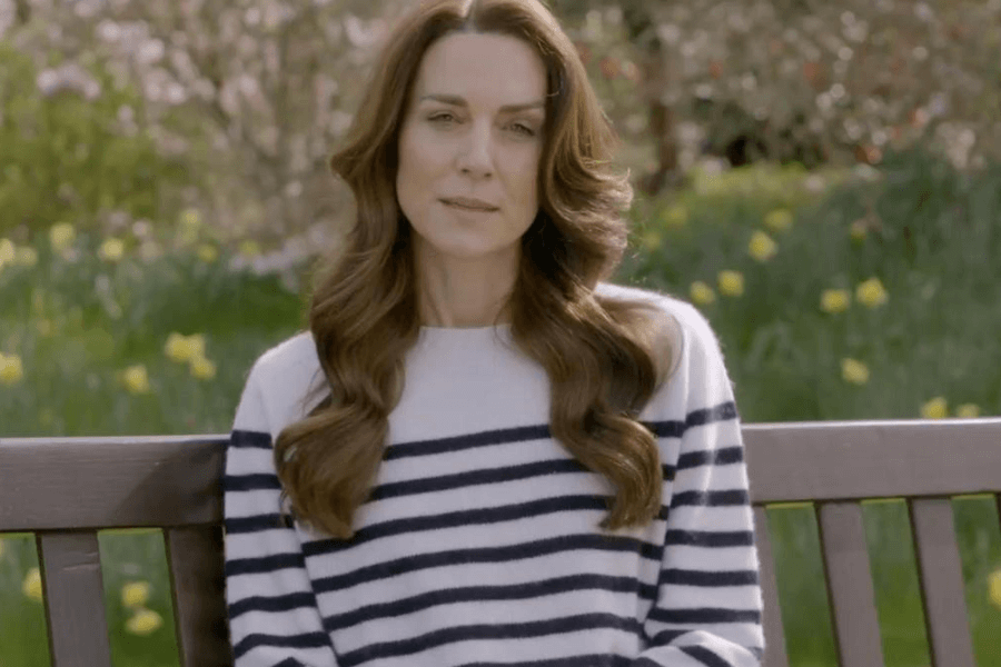 Kate Middleton sitting on a park bench