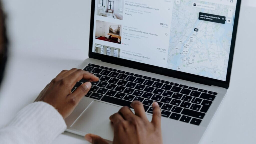 Person using a MacBook Pro on a white desk