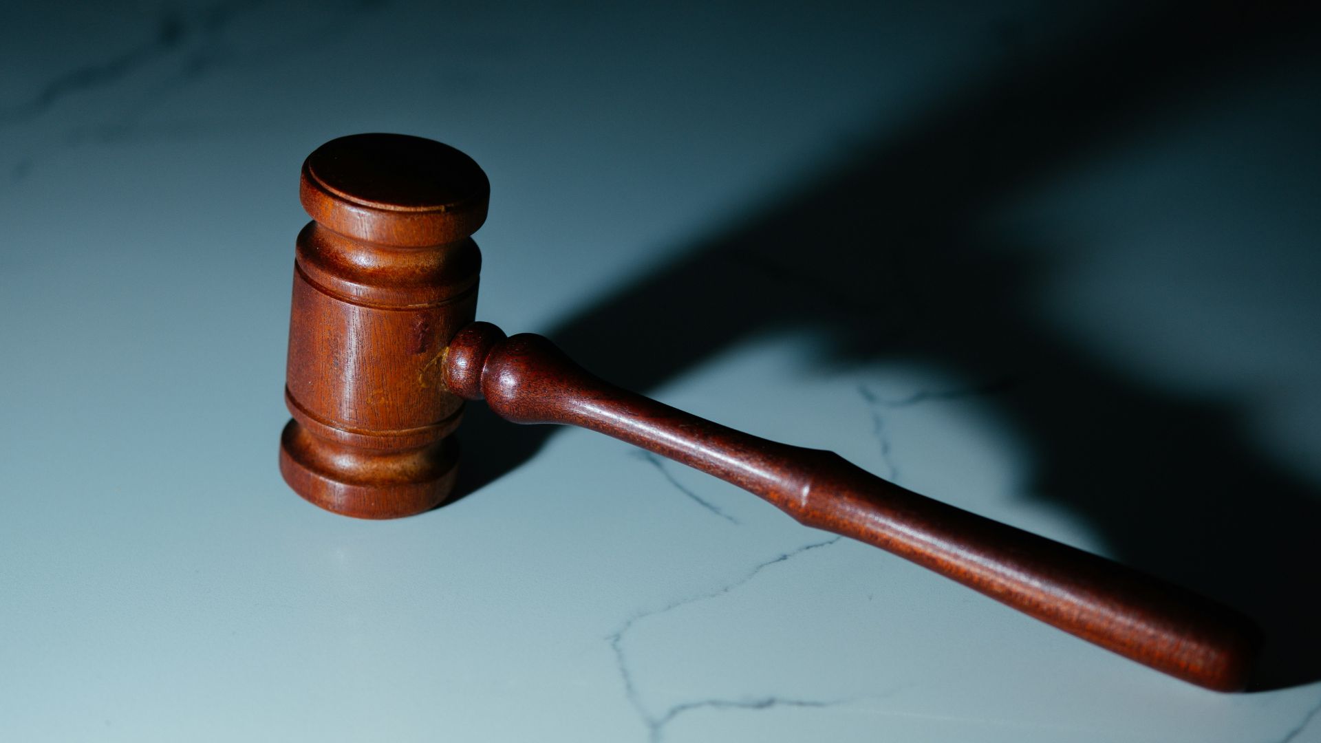 Wooden judge’s gavel sitting on top of a table