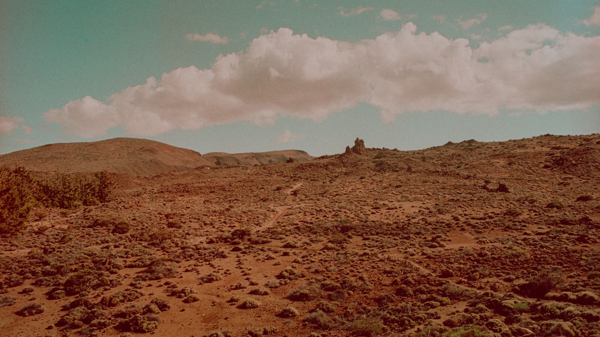 Rocky formation on Mars shaped like a helmet on dusty ground