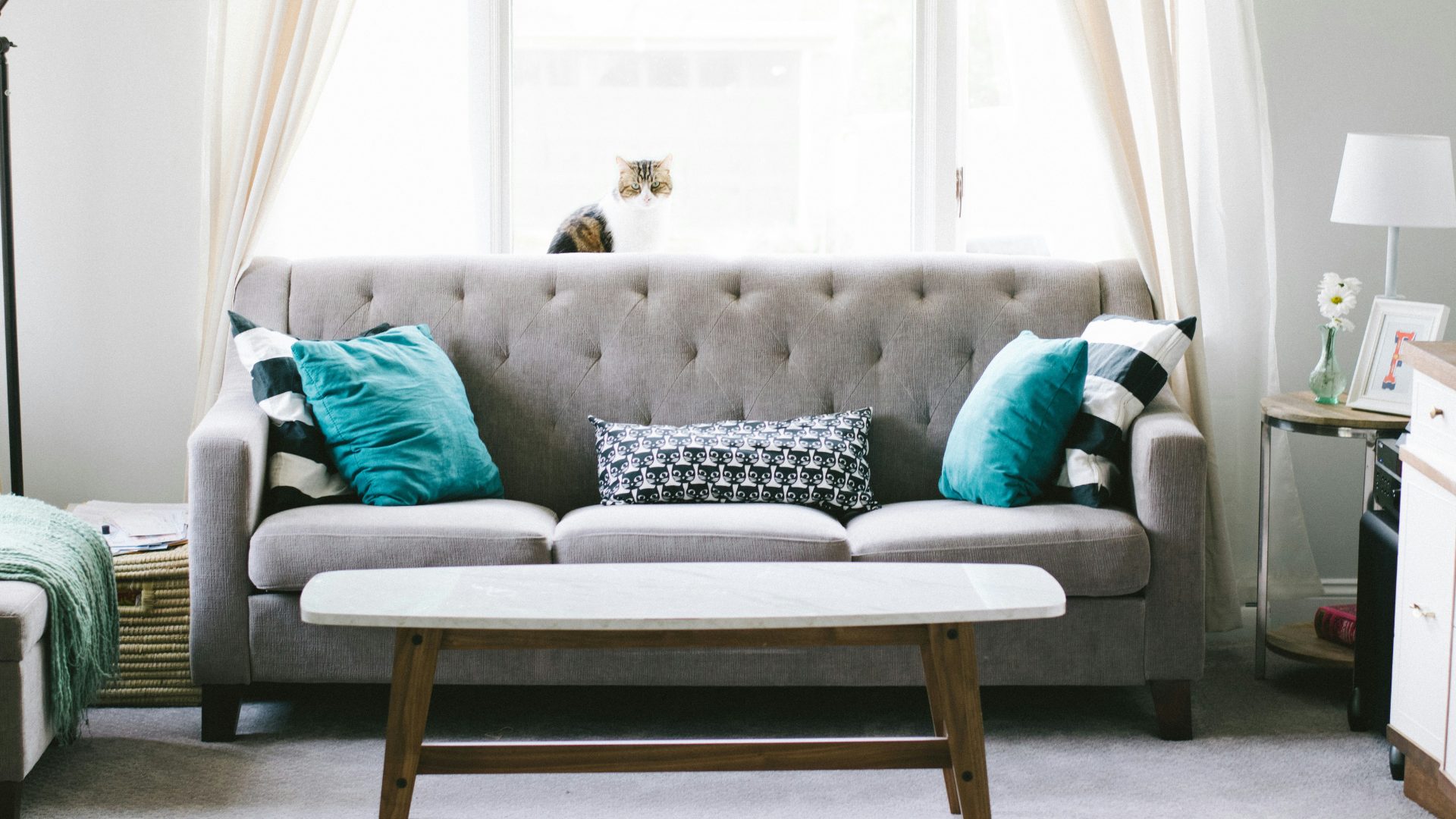 Minimalist living room with wooden coffee table and neutral-toned sofa