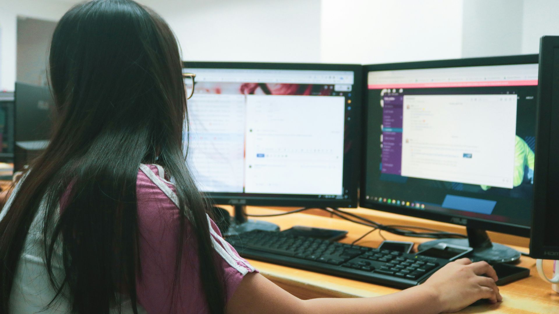 Construction worker walking on a site with scaffolding and equipment