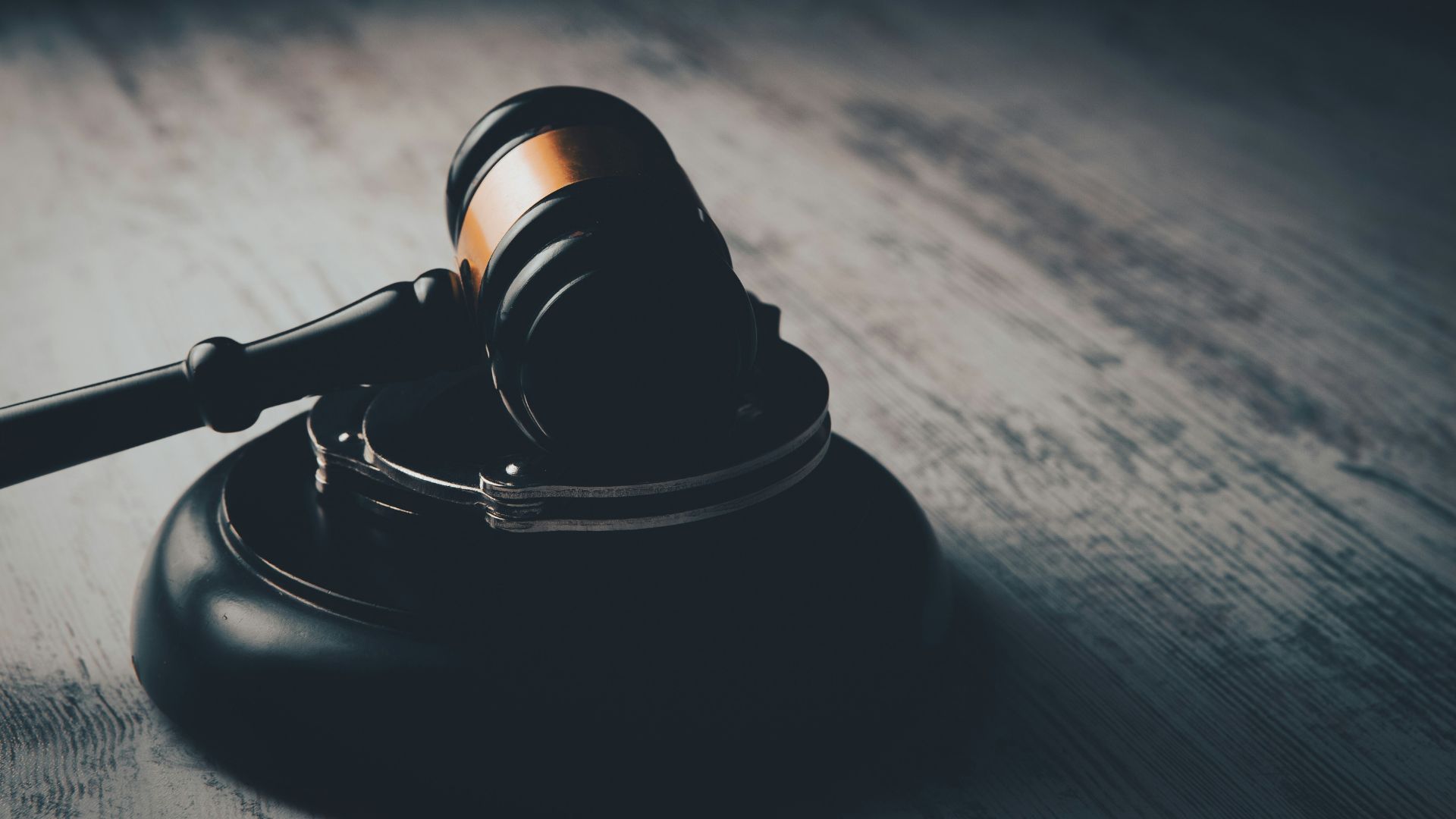 Judge’s gavel resting on a wooden table in a courtroom