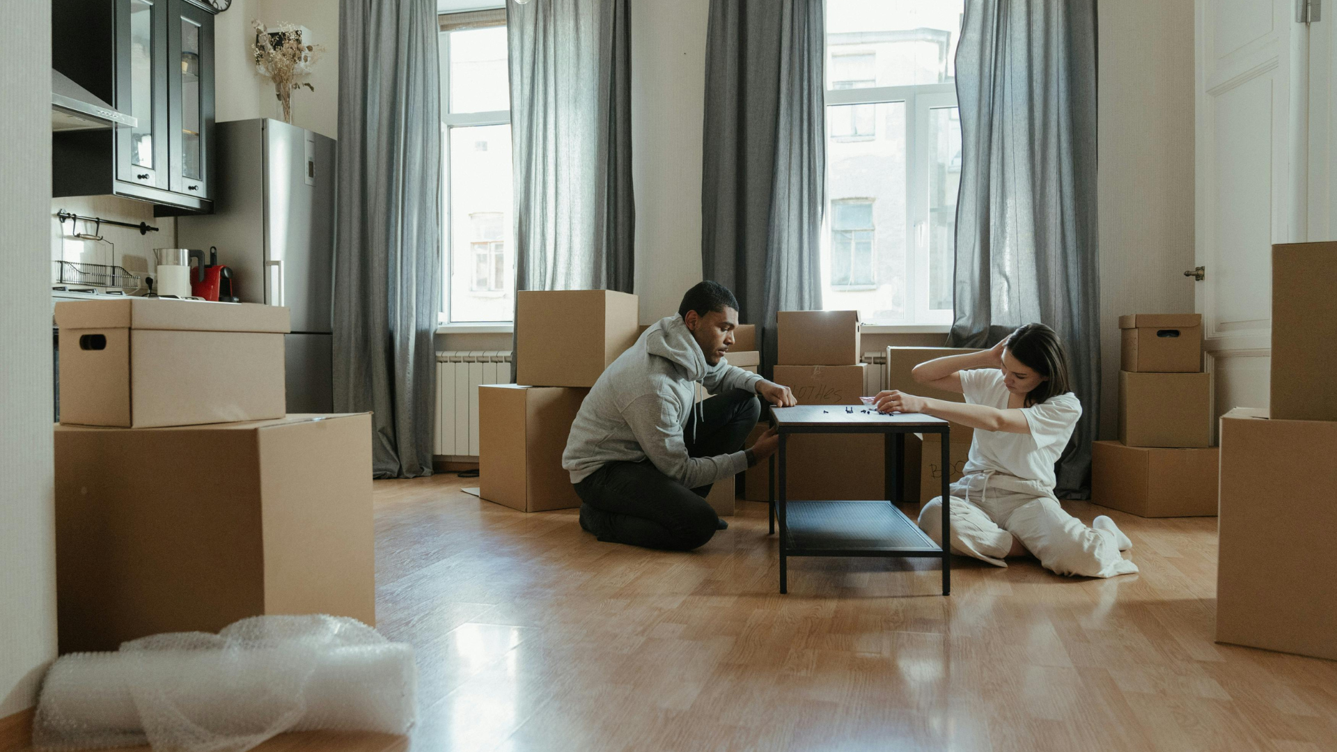 Man sitting on wooden chair while examining furniture joints