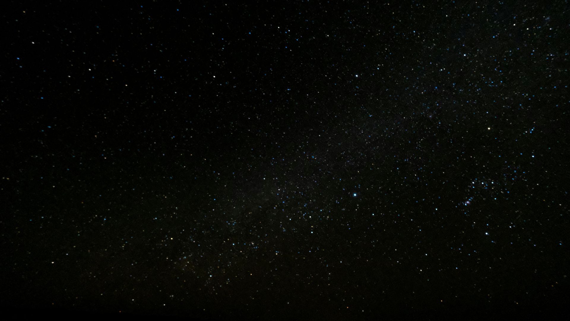 Night sky full of stars with faint details of the Milky Way visible
