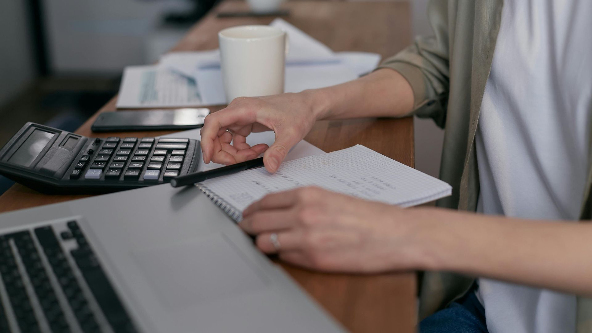 Person holding printed tax forms in their hands