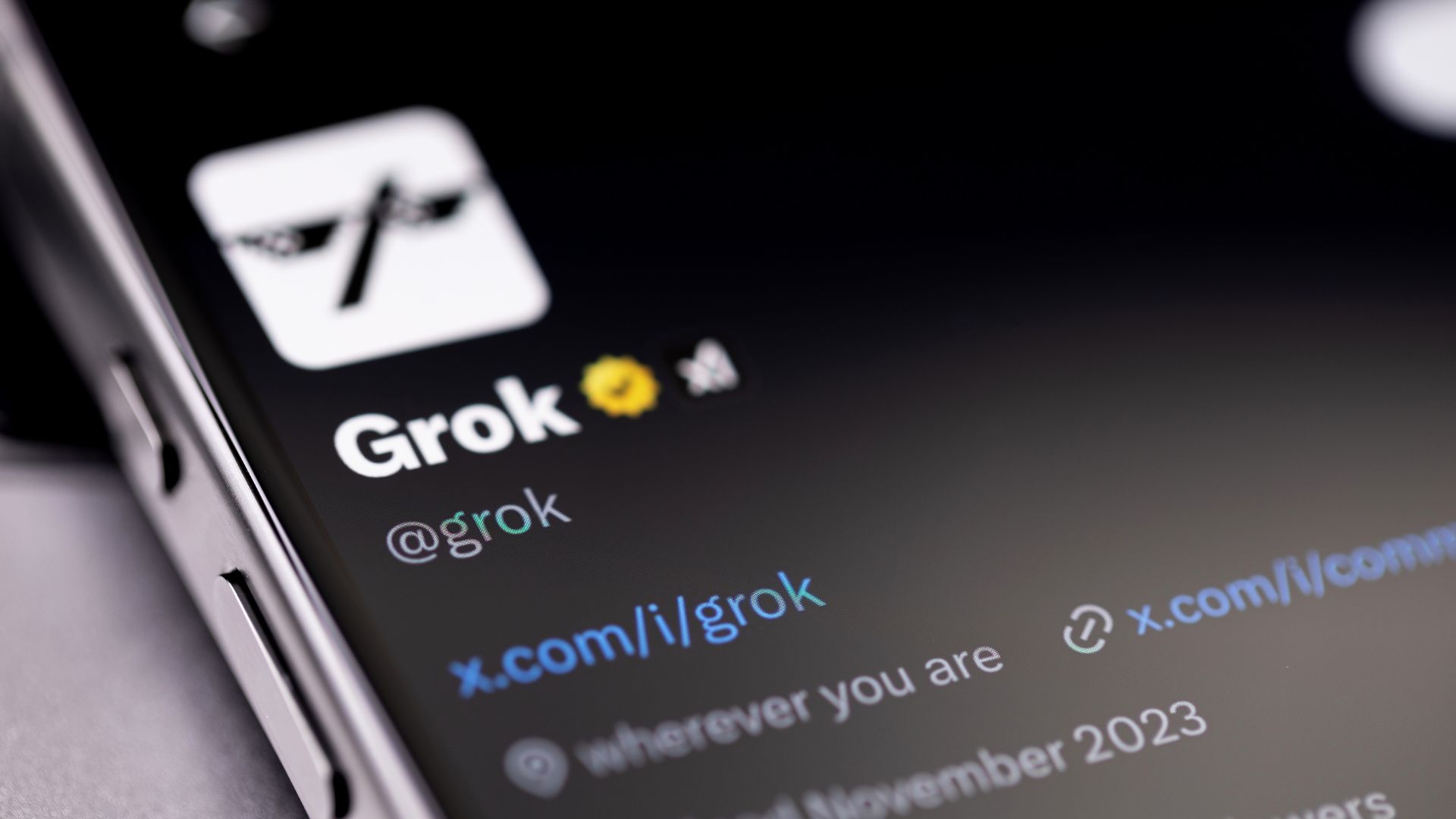 xAI Grok powered by Twitter X displayed on a digital screen