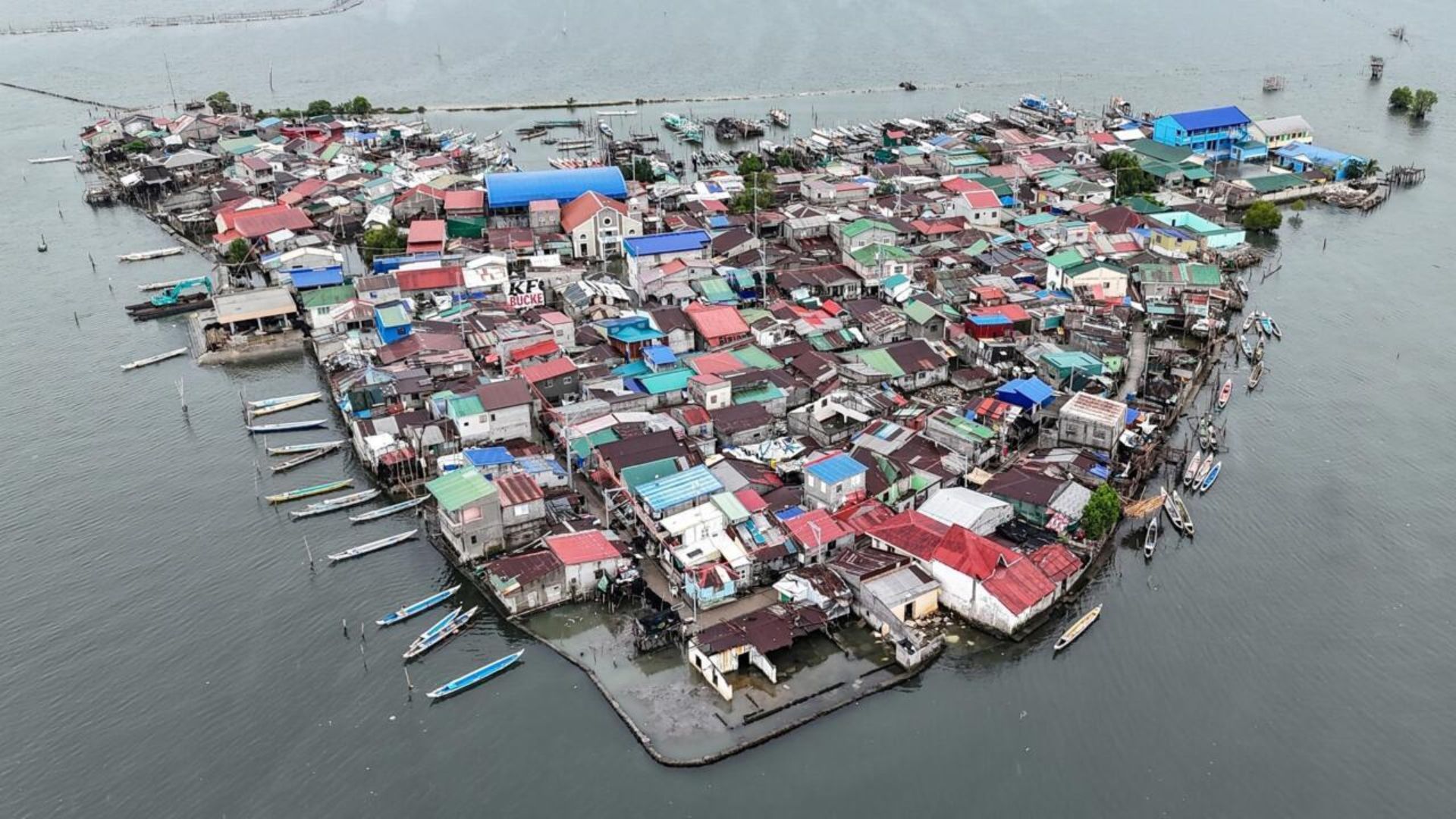 Residents walking through floodwaters on a sinking island in the Philippines