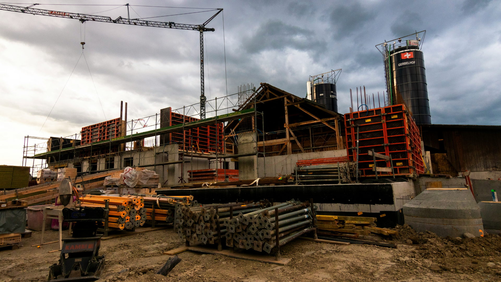 Construction site with crane and building framework in the background