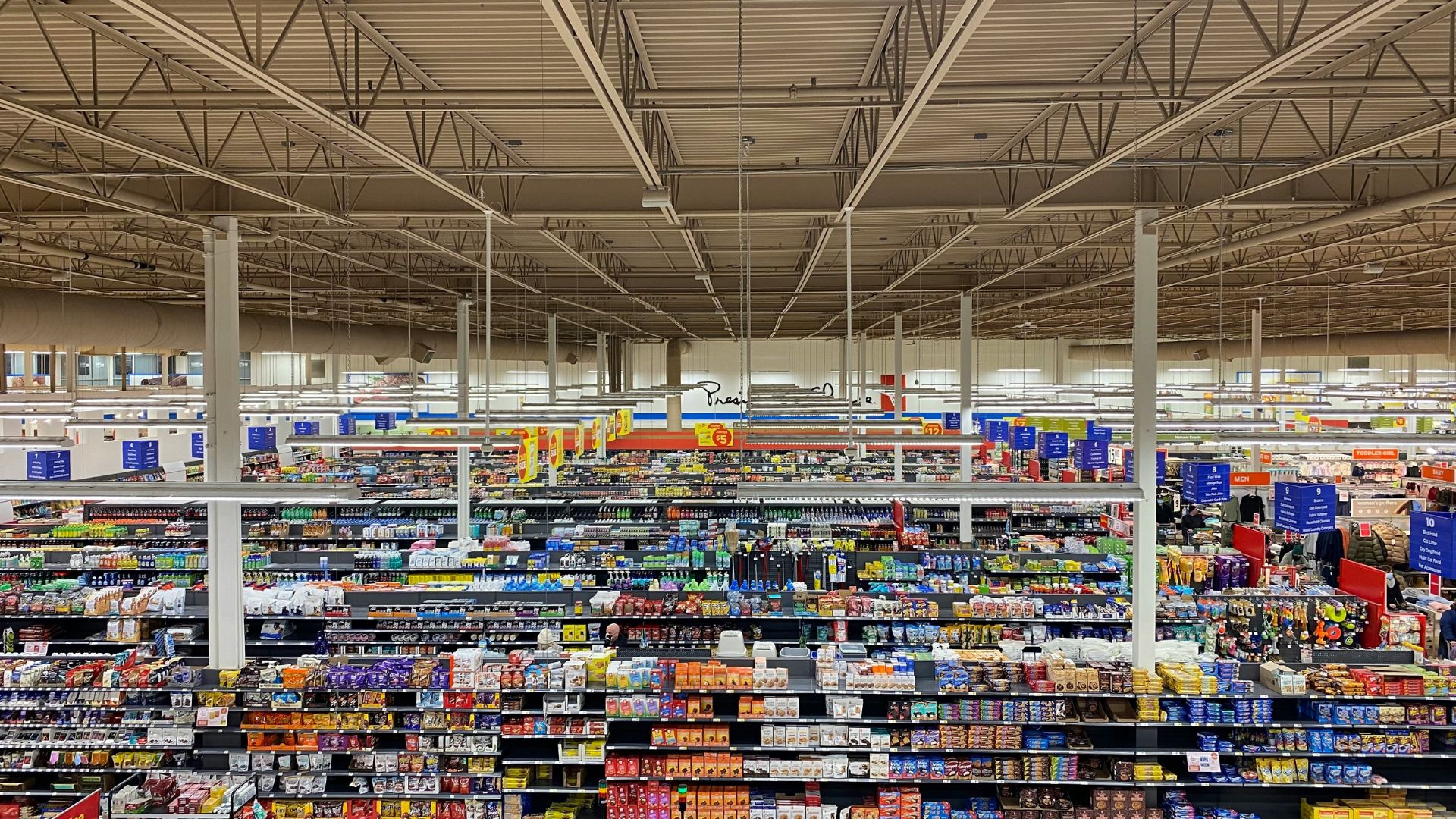 Large grocery store interior with aisles filled with food products