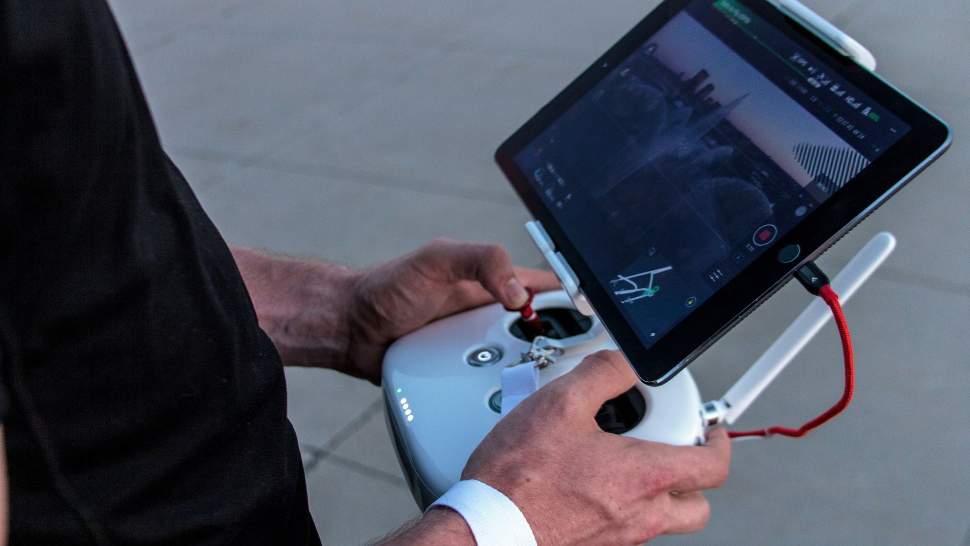 Person holding a quadcopter controller outdoors