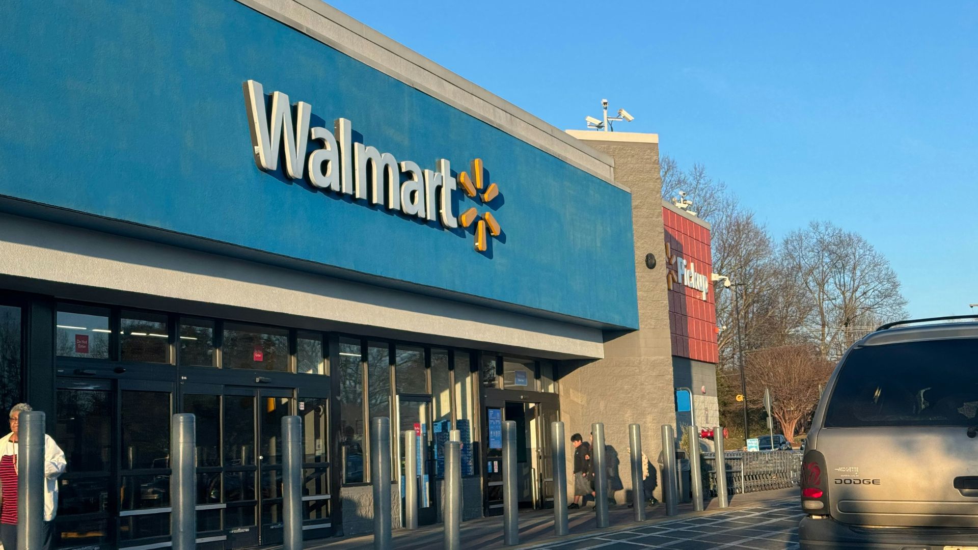 Walmart store with a parking lot and cars in front