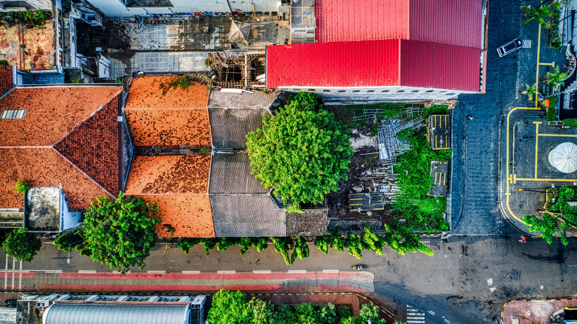 Aerial view of houses and a concrete road in a neighborhood