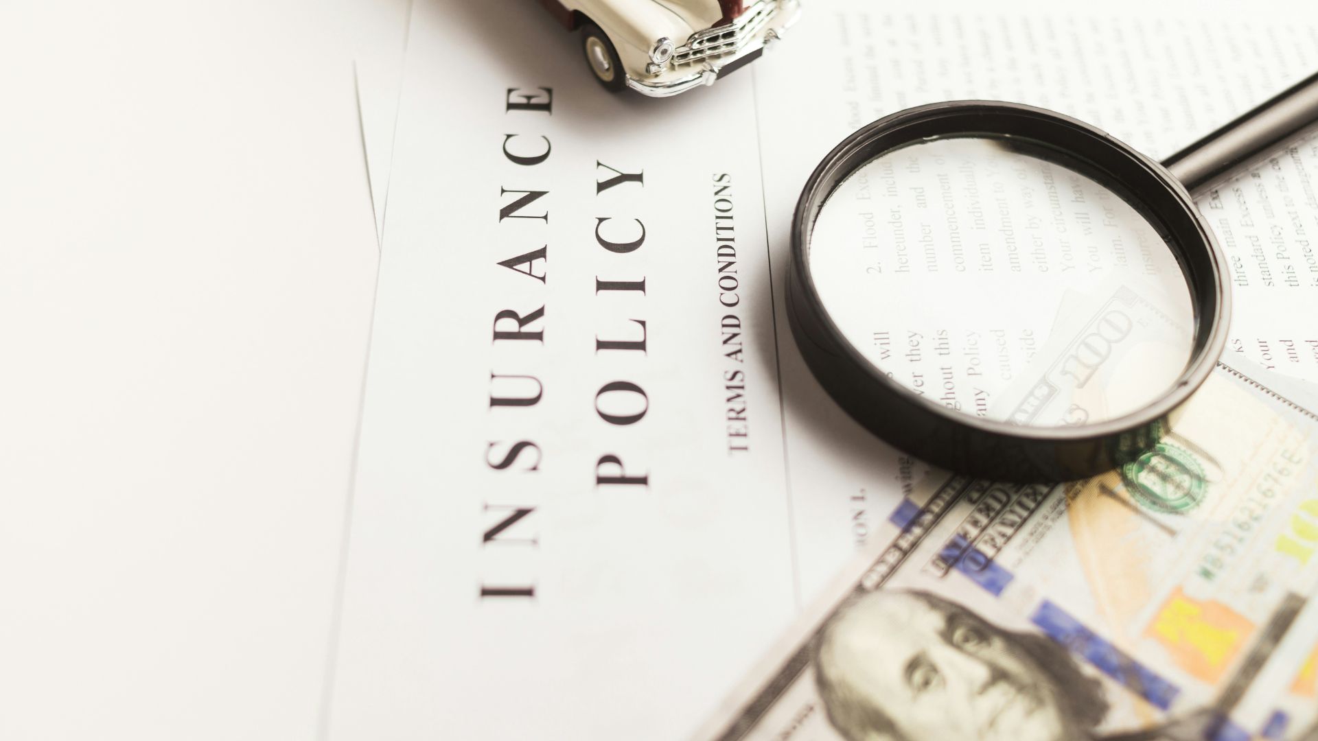 Magnifying glass placed on top of insurance documents