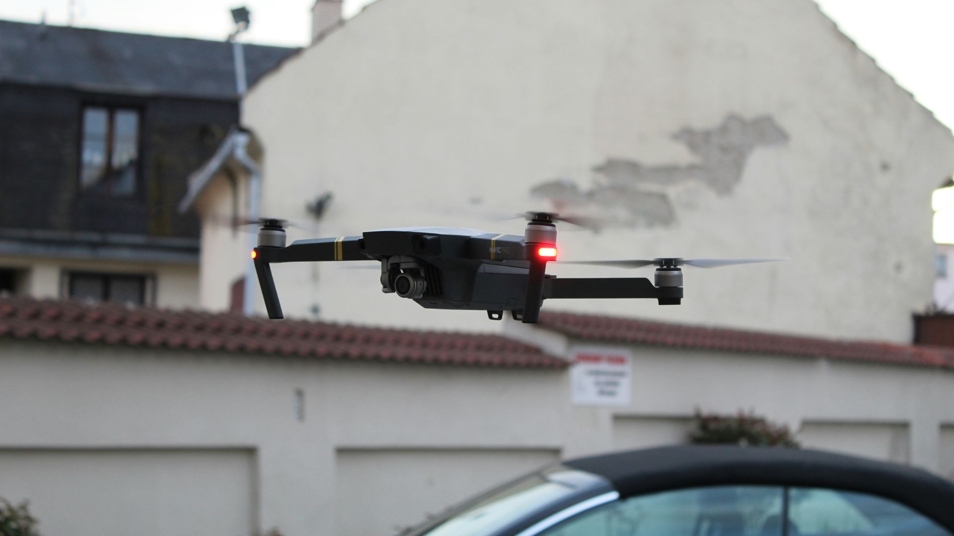 Small black and red drone placed on the ground