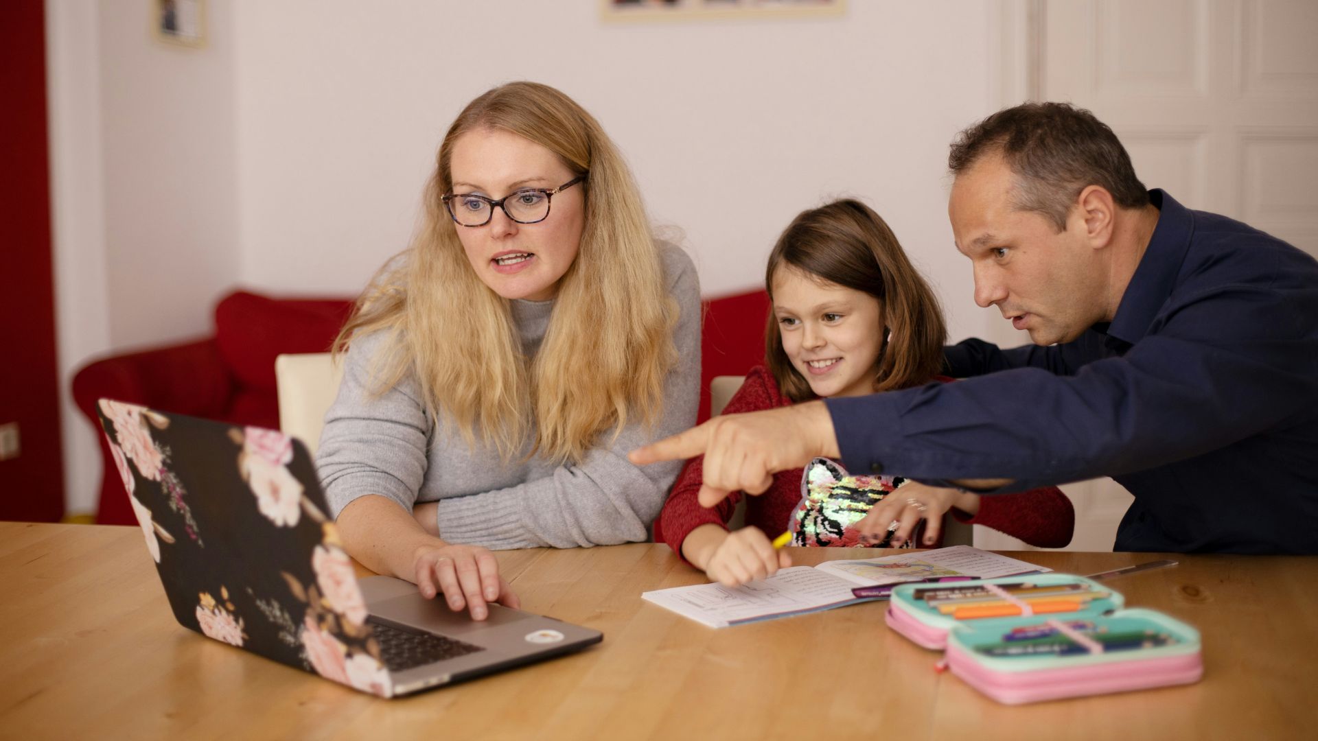 Woman helping a young boy with schoolwork at home