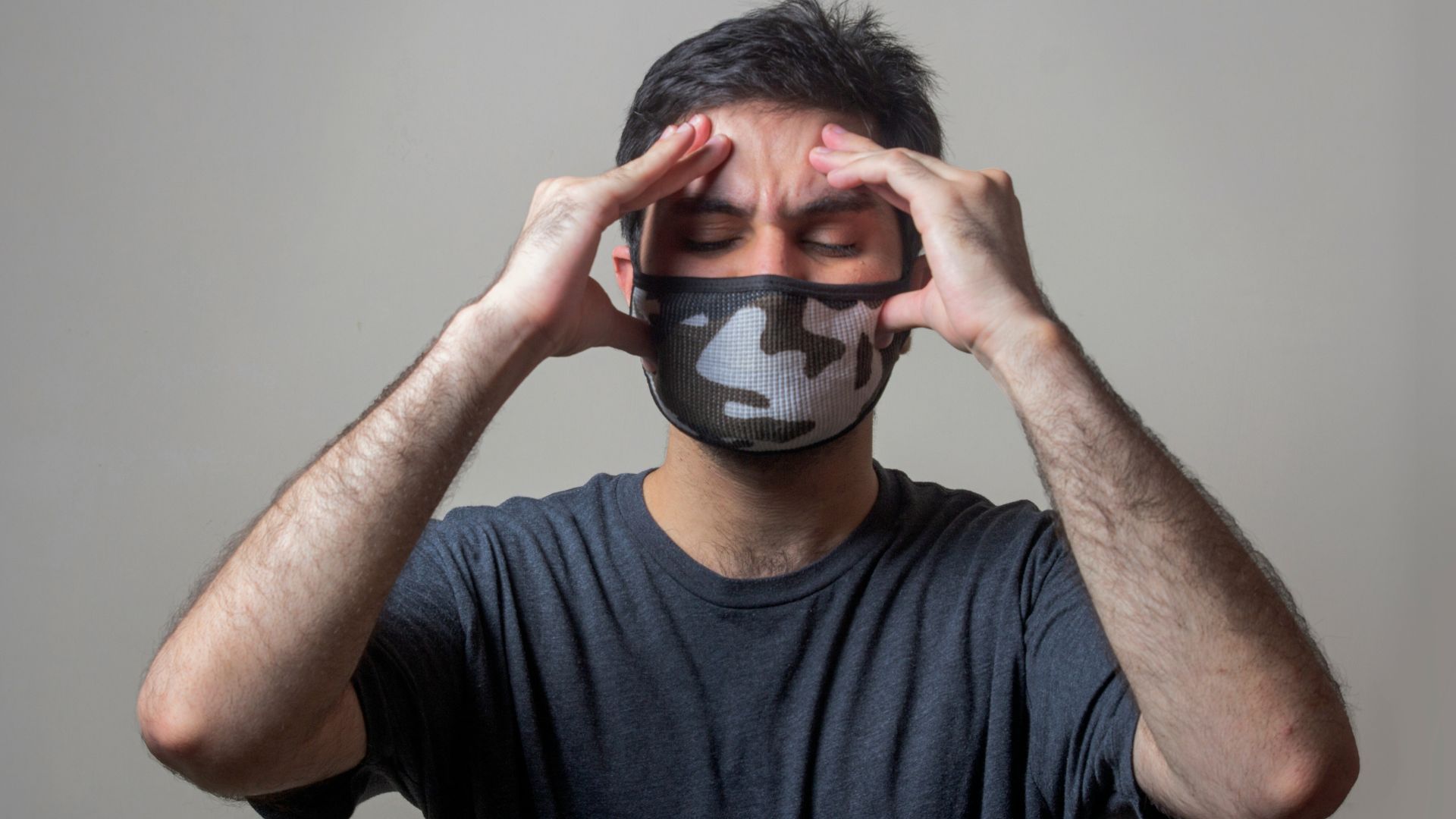Man in black t-shirt wearing black and white mask