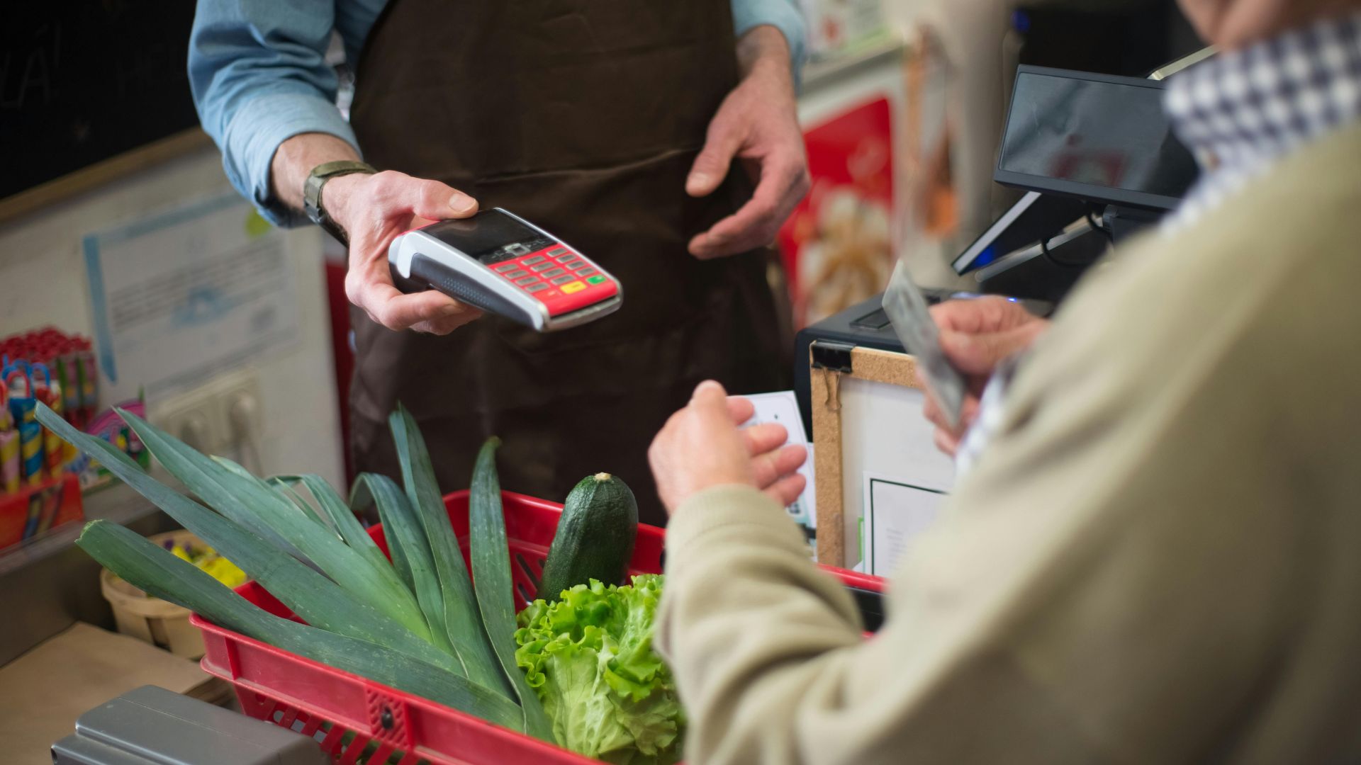 Customer paying with a card at a checkout counter