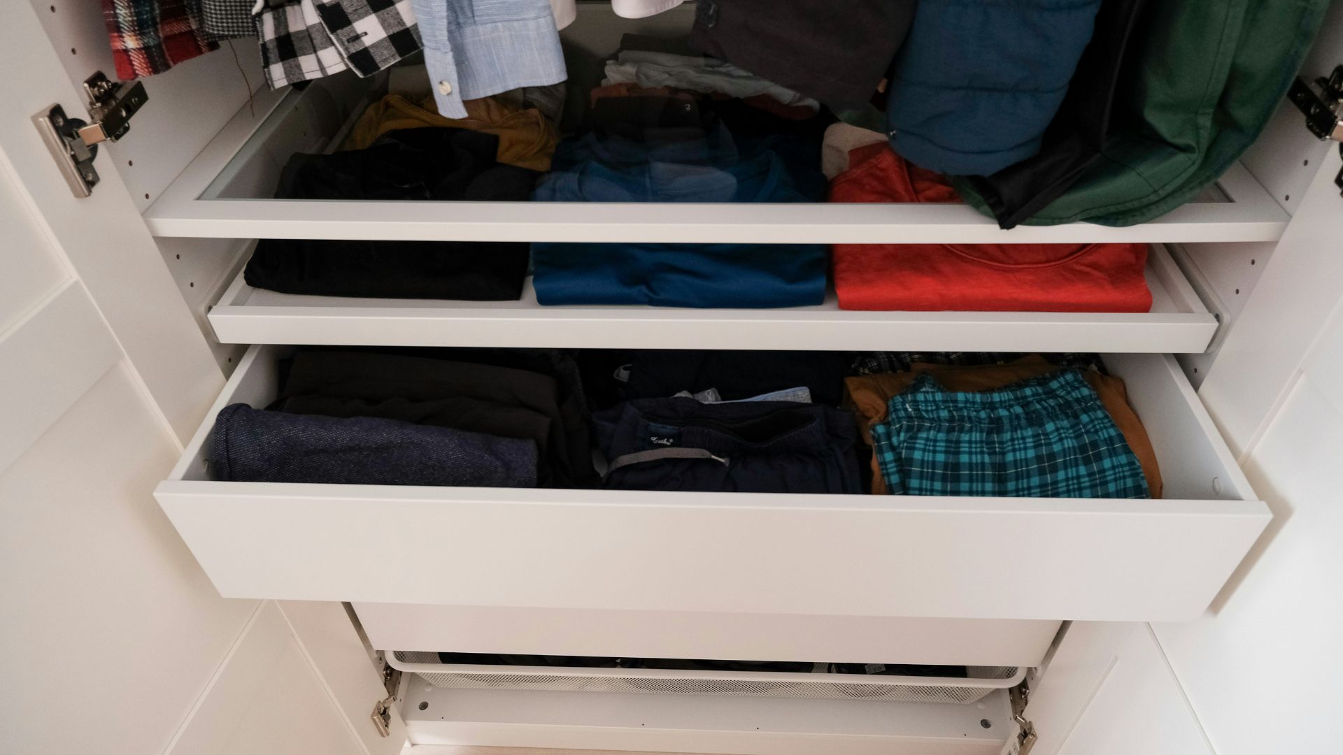 Closet filled with clothes on hangers