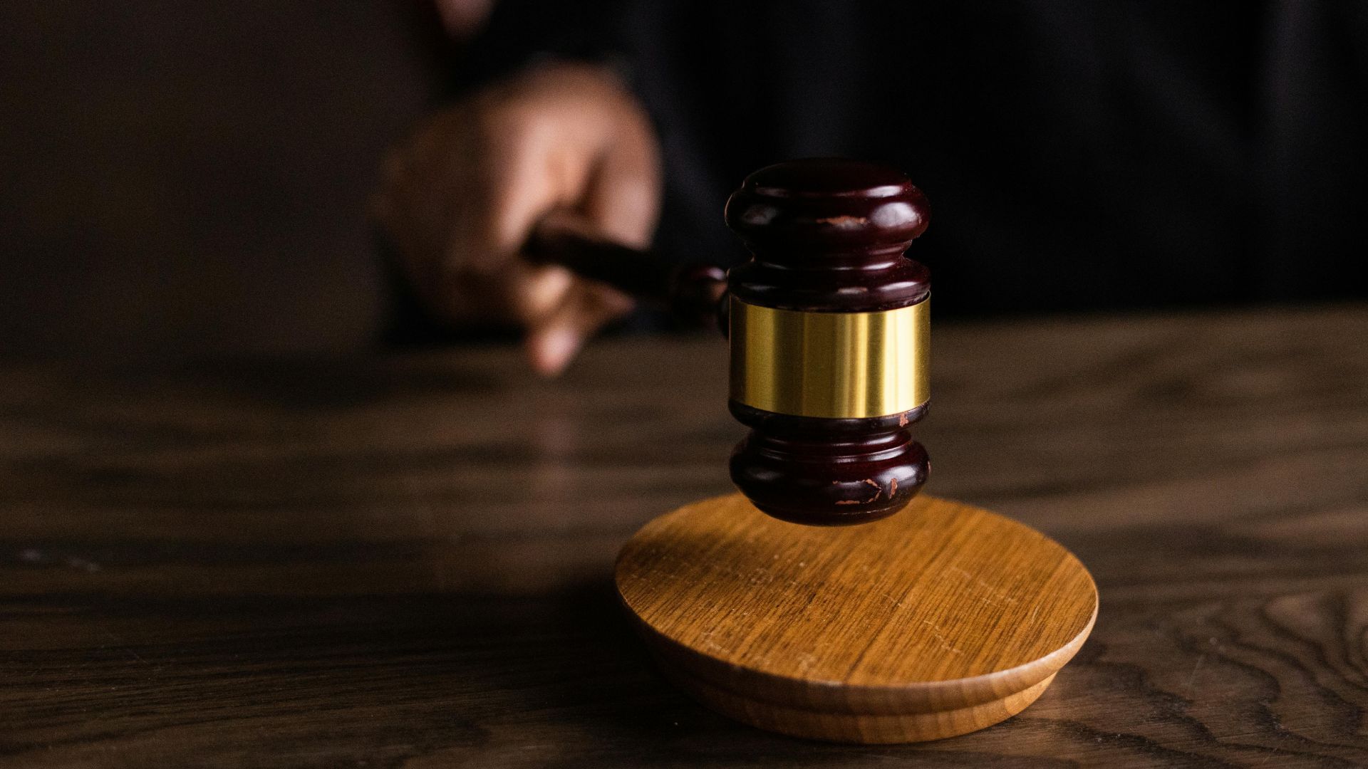  Wooden gavel resting on a wooden table