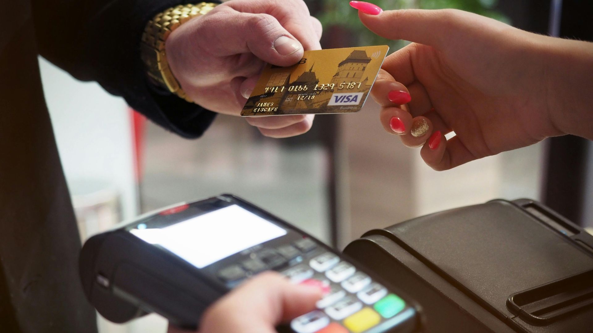 Black payment terminal on a wooden counter