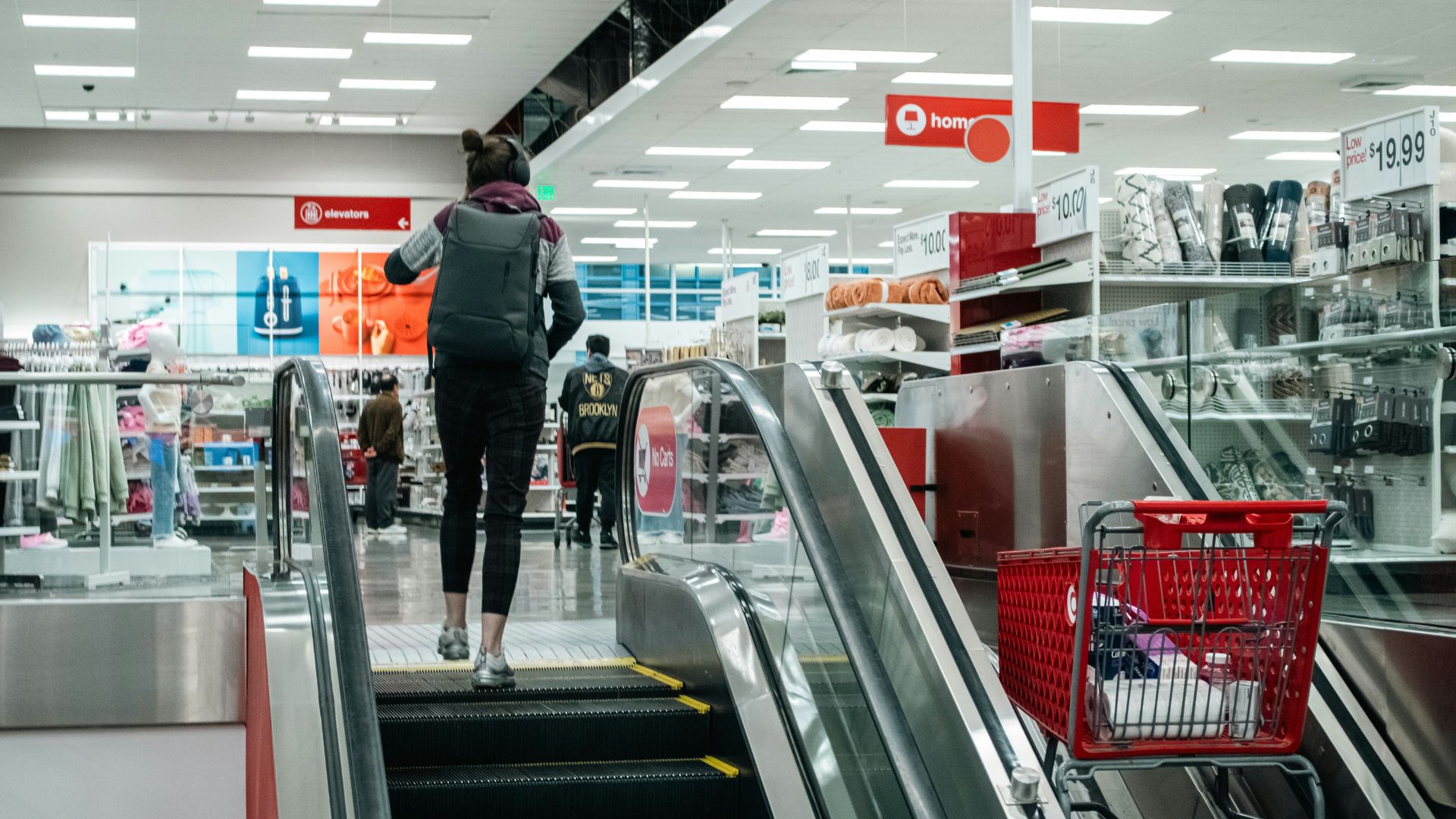 Person walking up an escalator inside a Target store