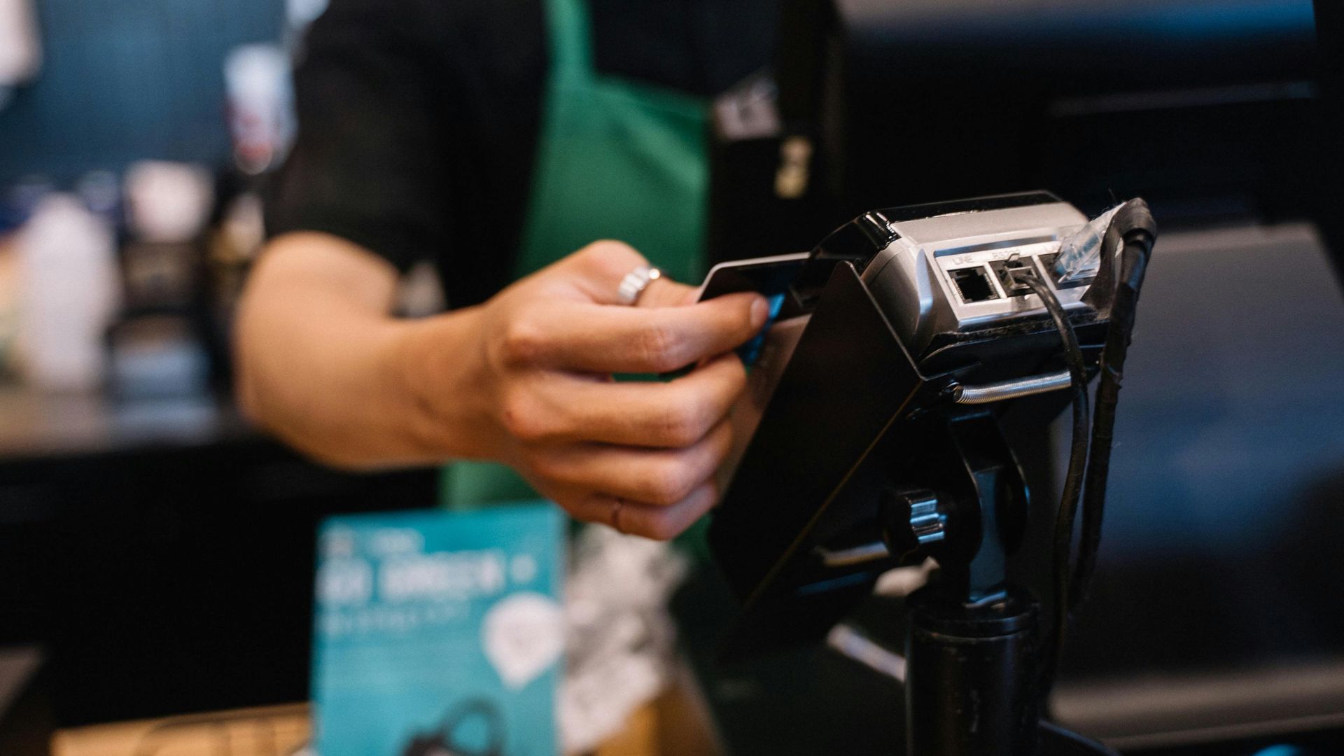 Person holding a smartphone to make a contactless payment
