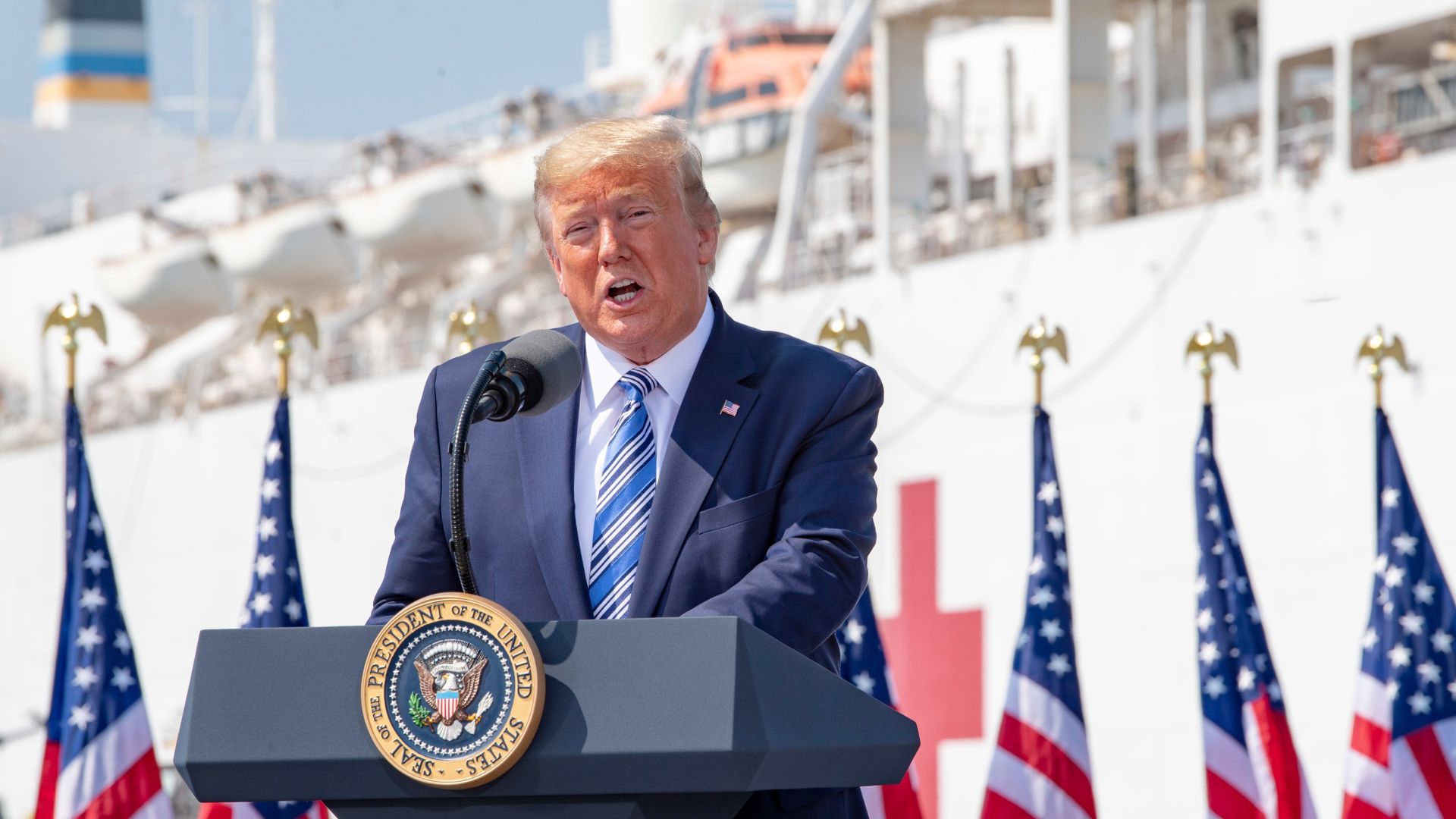 President Donald Trump speaking at a podium during a press event
