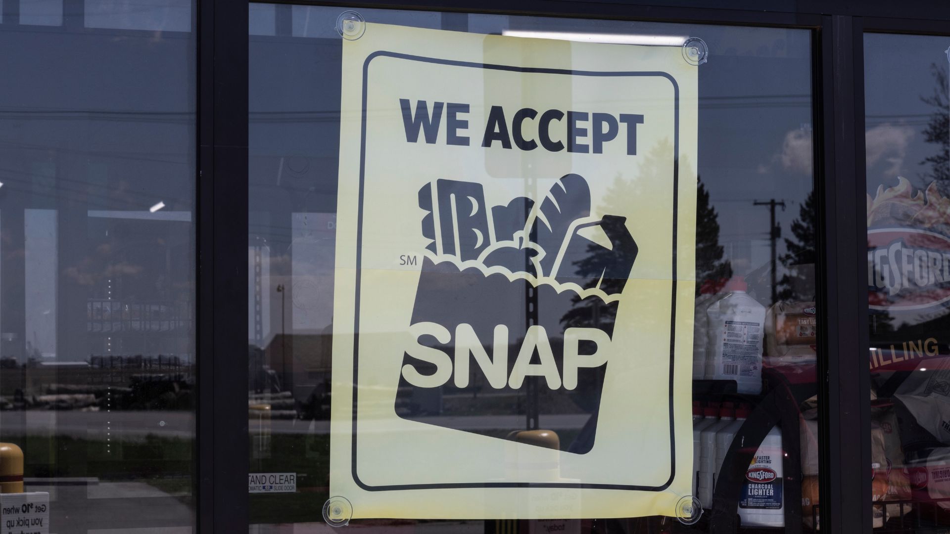 SNAP EBT card held over grocery counter at a retail store in Logansport