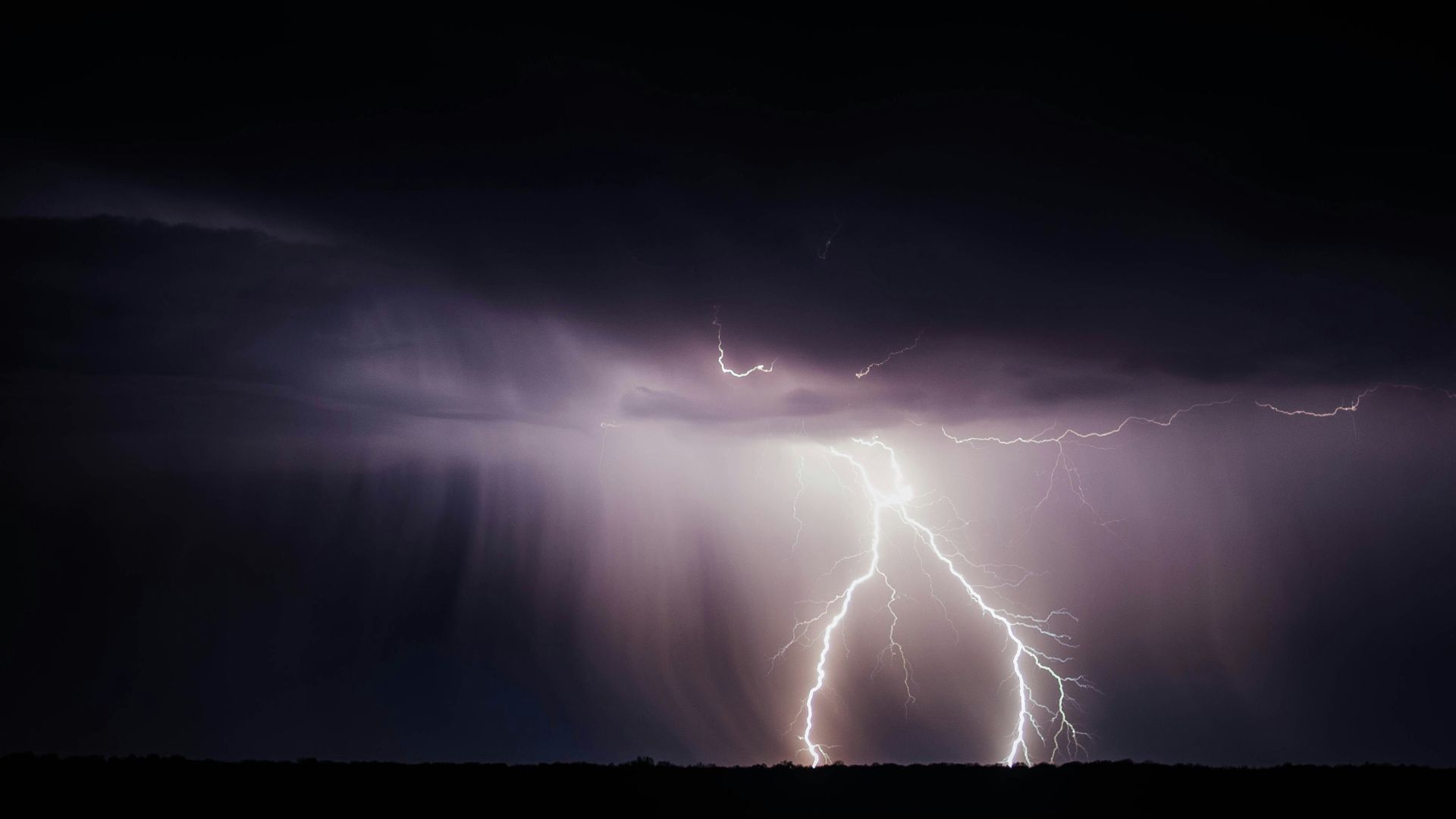 Thunderstorm forming over the Pacific Ocean with dark clouds and lightning