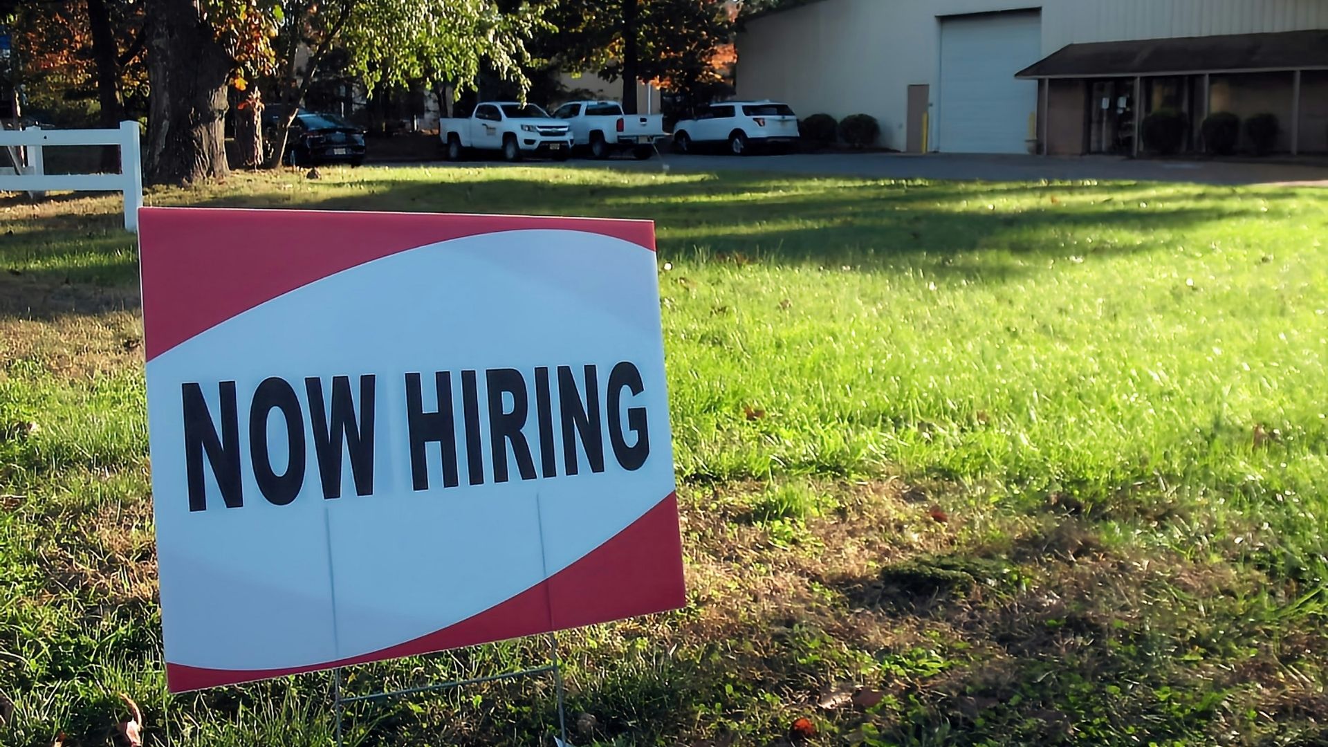 “Now Hiring” sign displayed outside a retail building