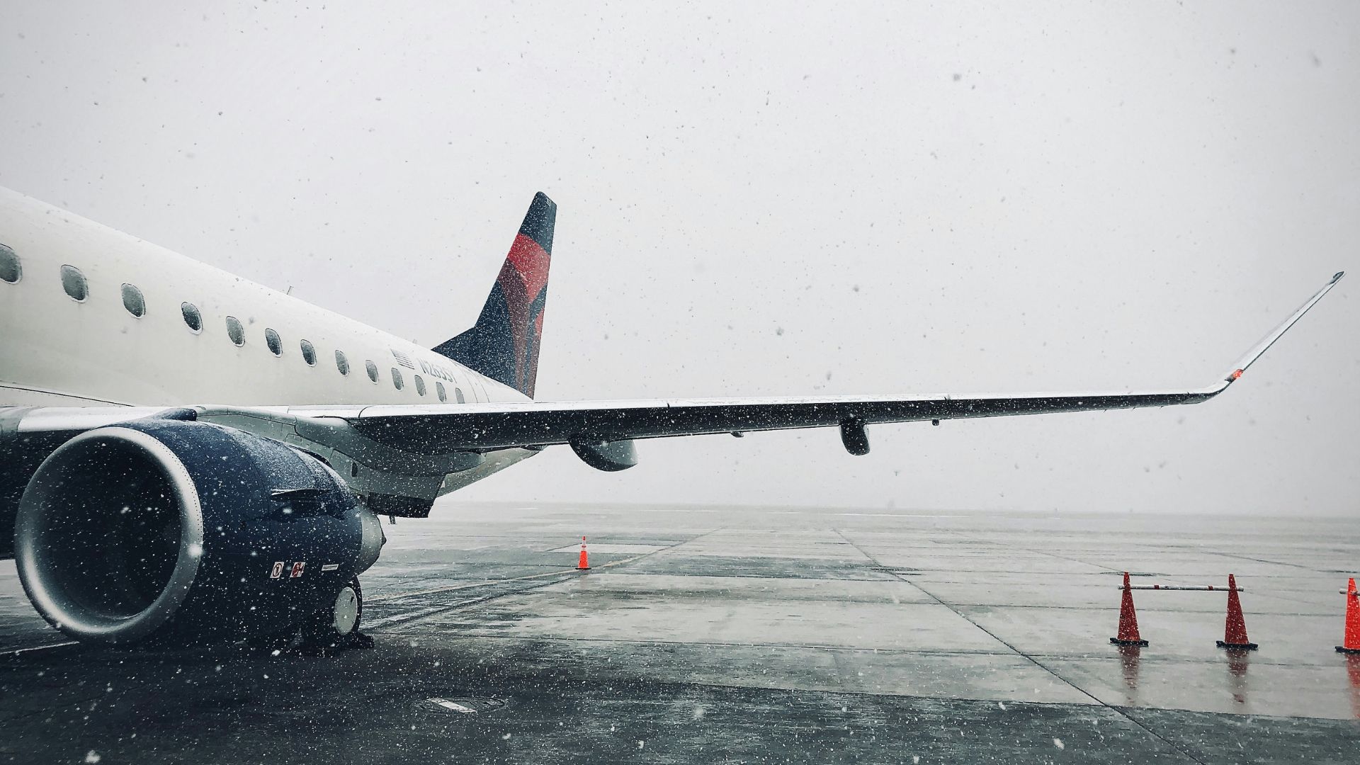 Passenger plane taxiing at an airport on a cloudy day
