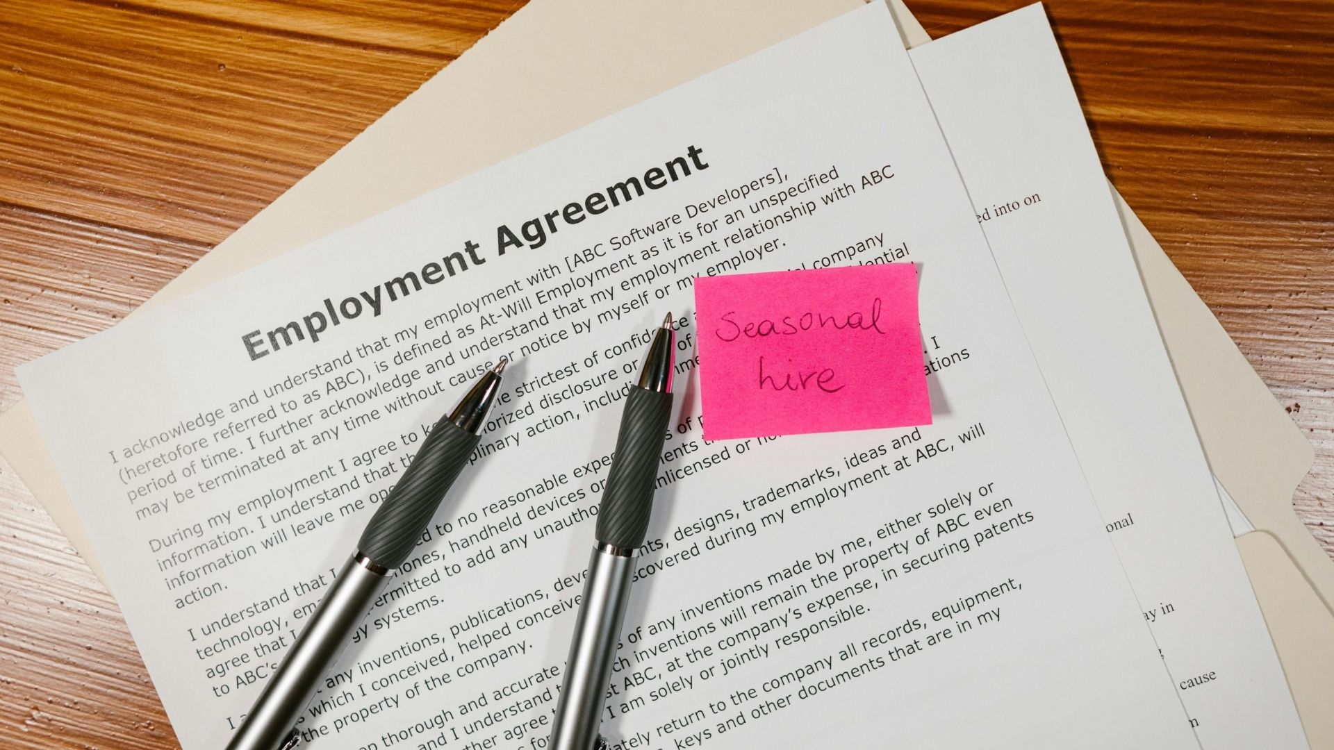 Employment contract with a pen resting on top of the paper