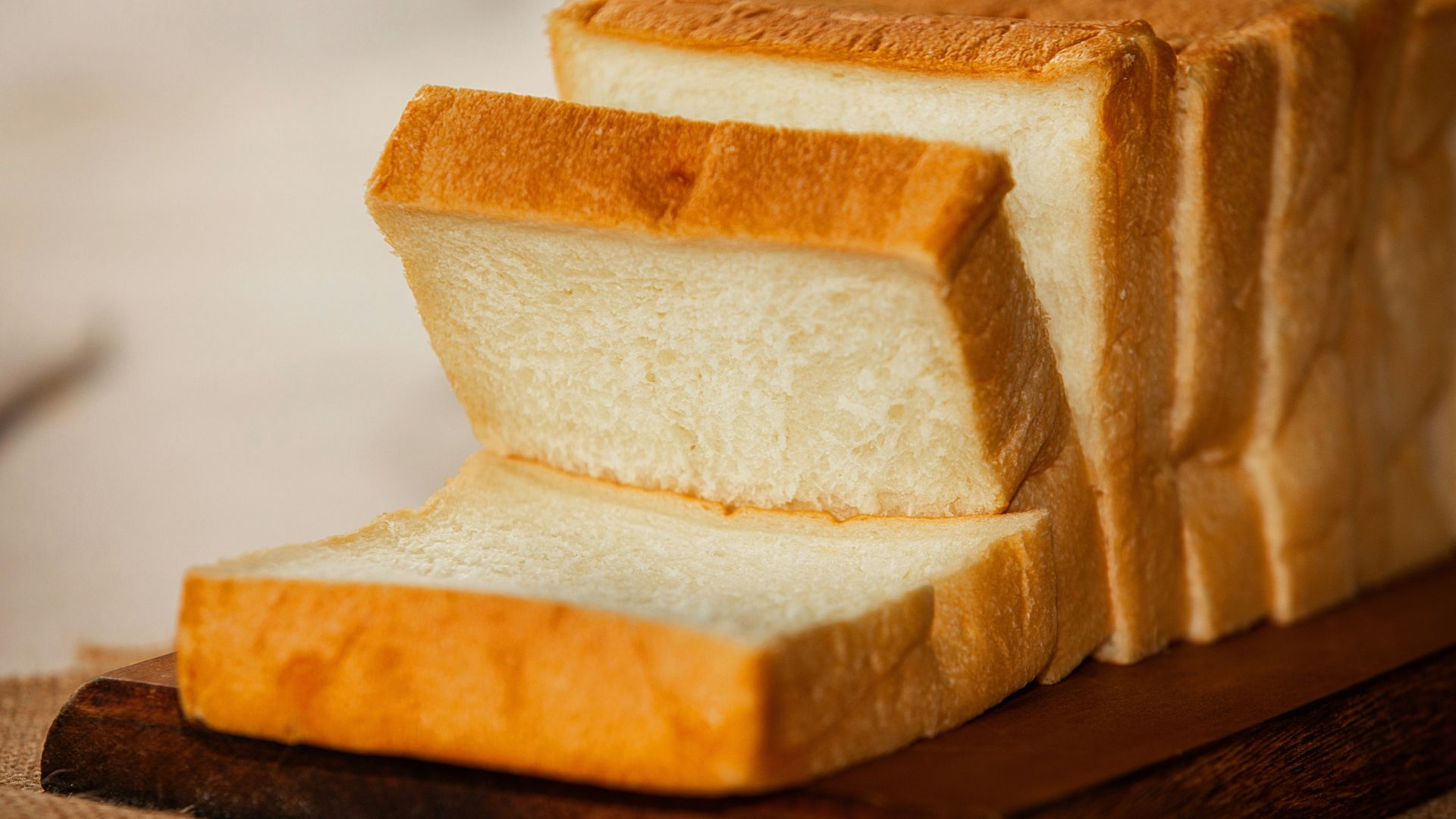 Slices of brown bread served on a white ceramic plate