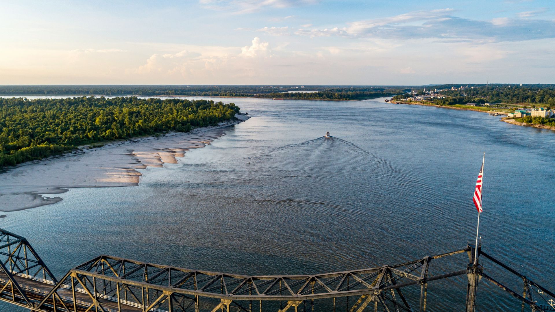 Wooden dock extending into the sea beneath white clouds