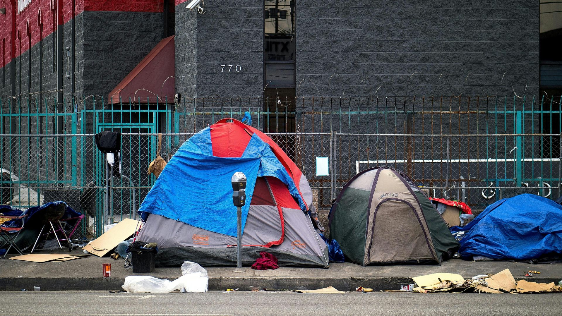 Row of tents set up along a city sidewalk