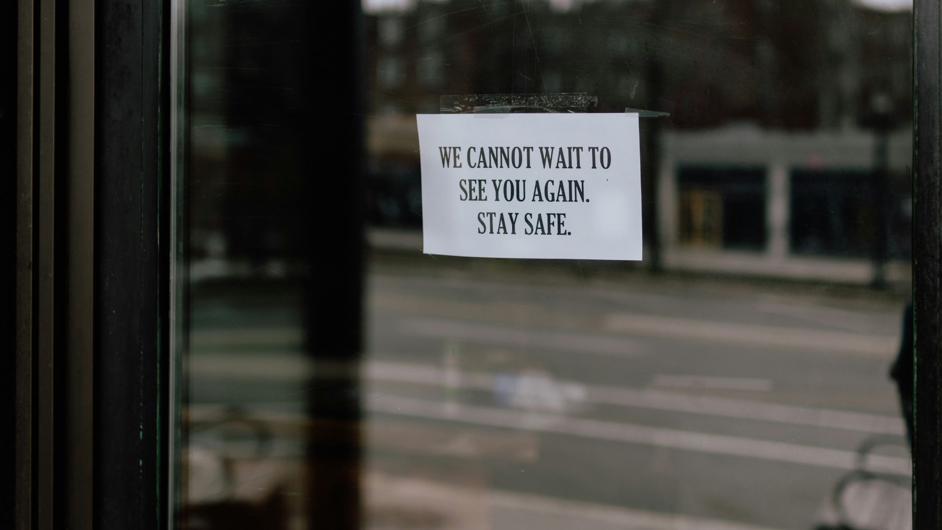Printed letter with visible black and white text on a wooden surface