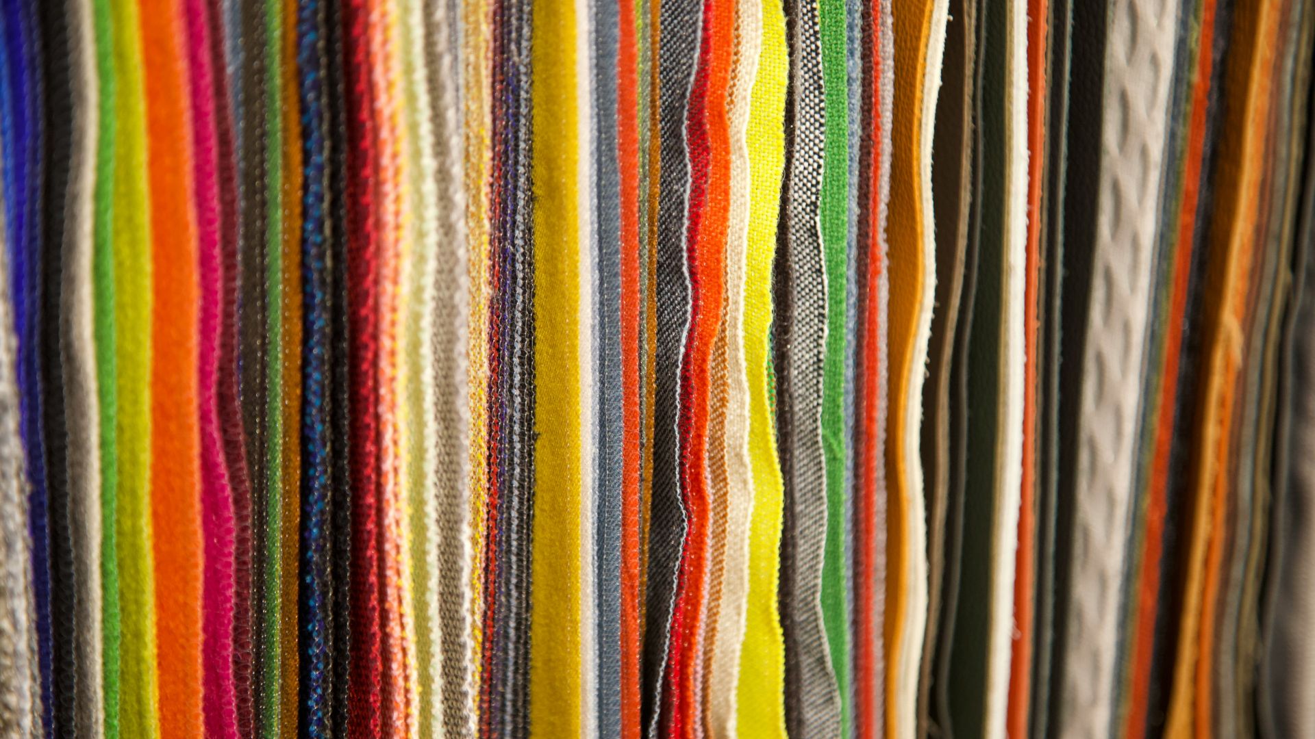 Close-up of sharpened colored pencils lined up on a desk