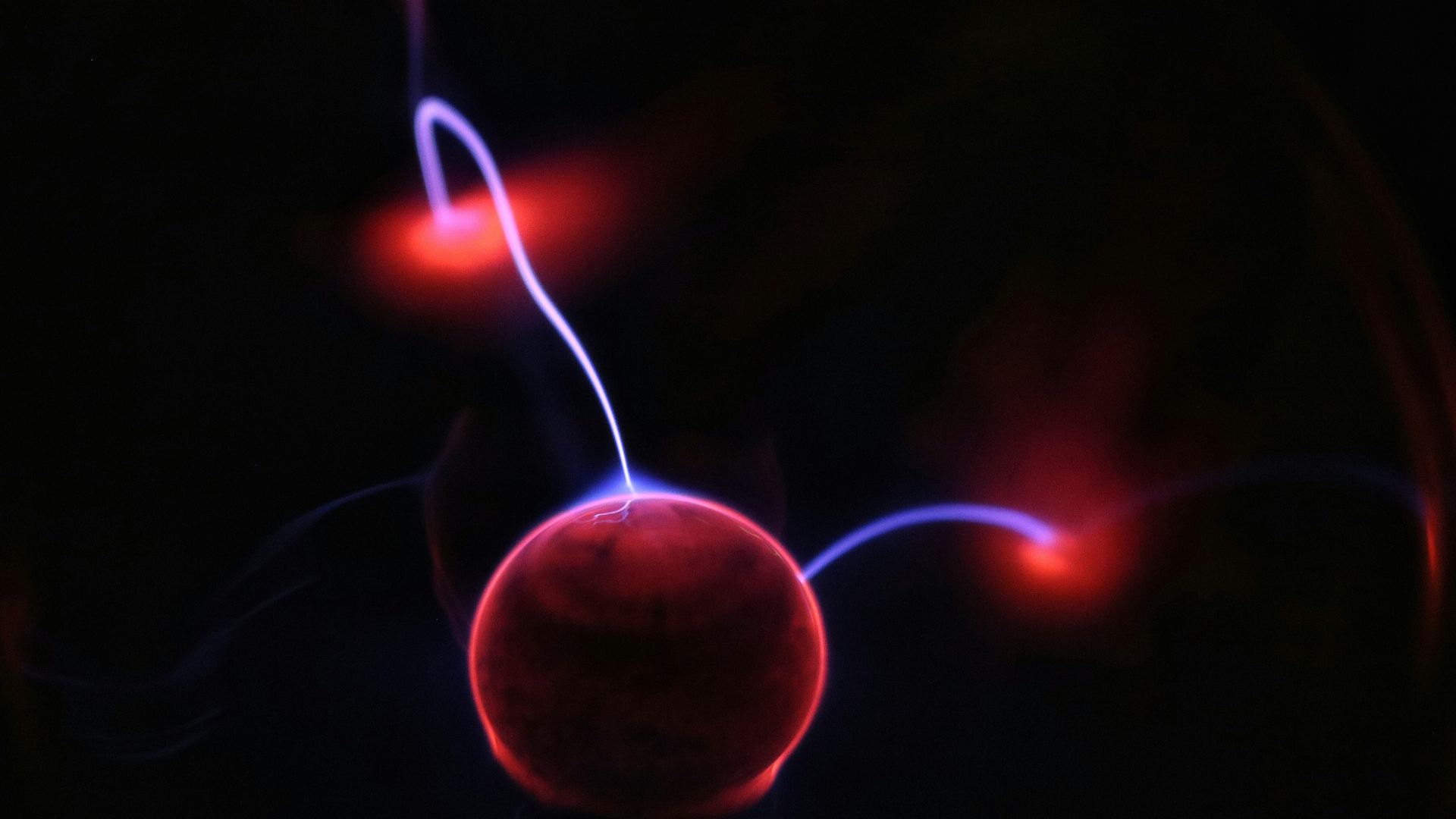 Abstract red and orange bokeh lights representing futuristic energy or data transfer.