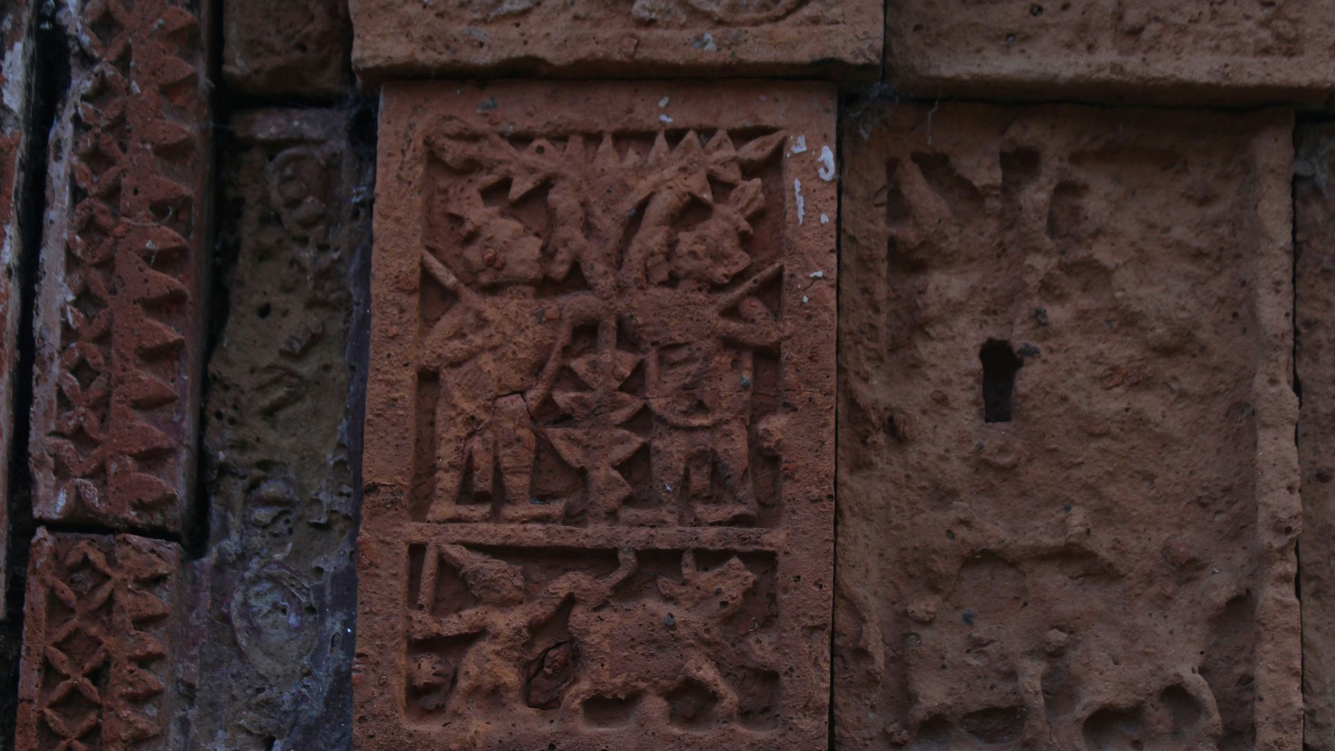 Close-up of engraved carvings on an ancient stone surface