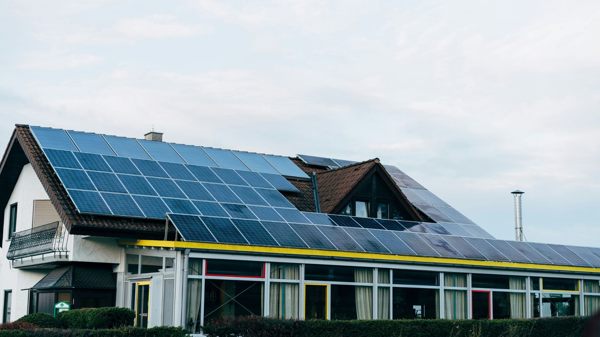 Home with rooftop solar panels in warm sunlight