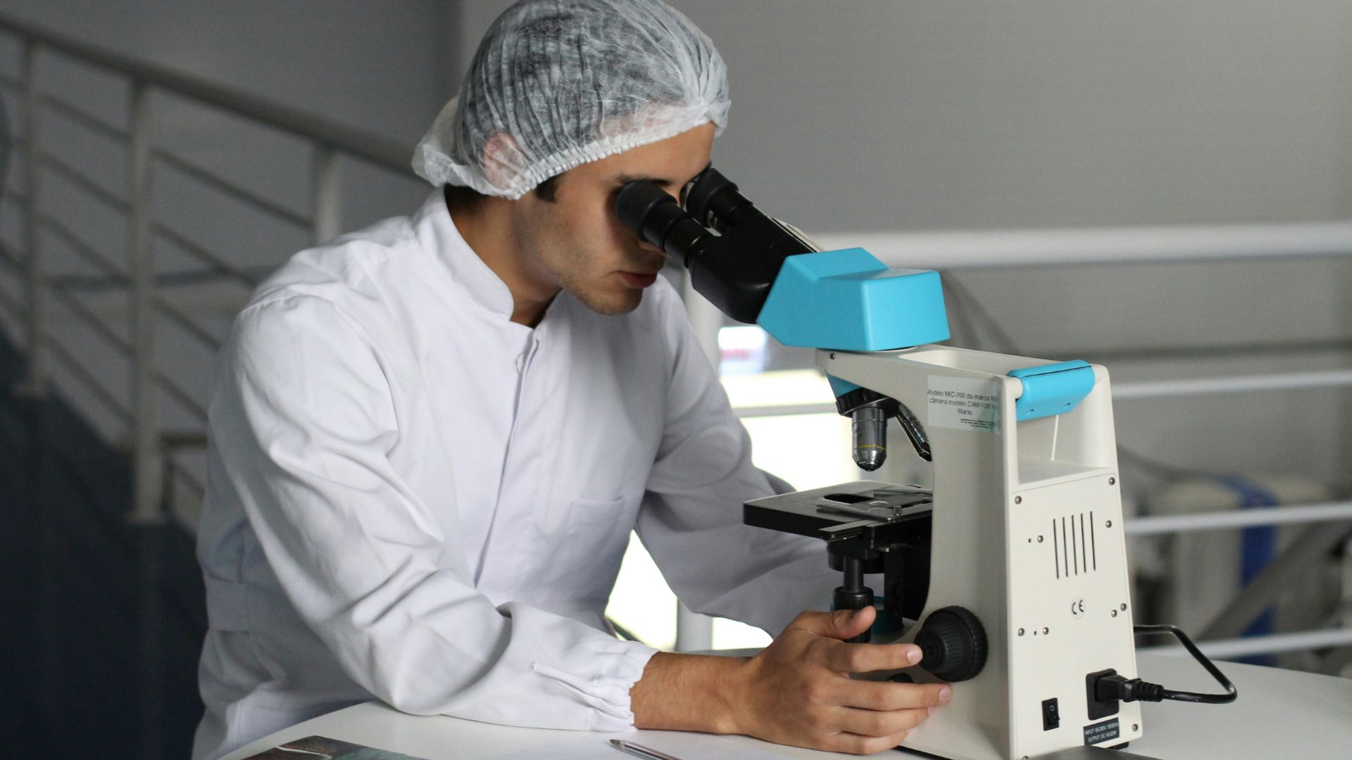 Scientist looking into a microscope in a laboratory setting