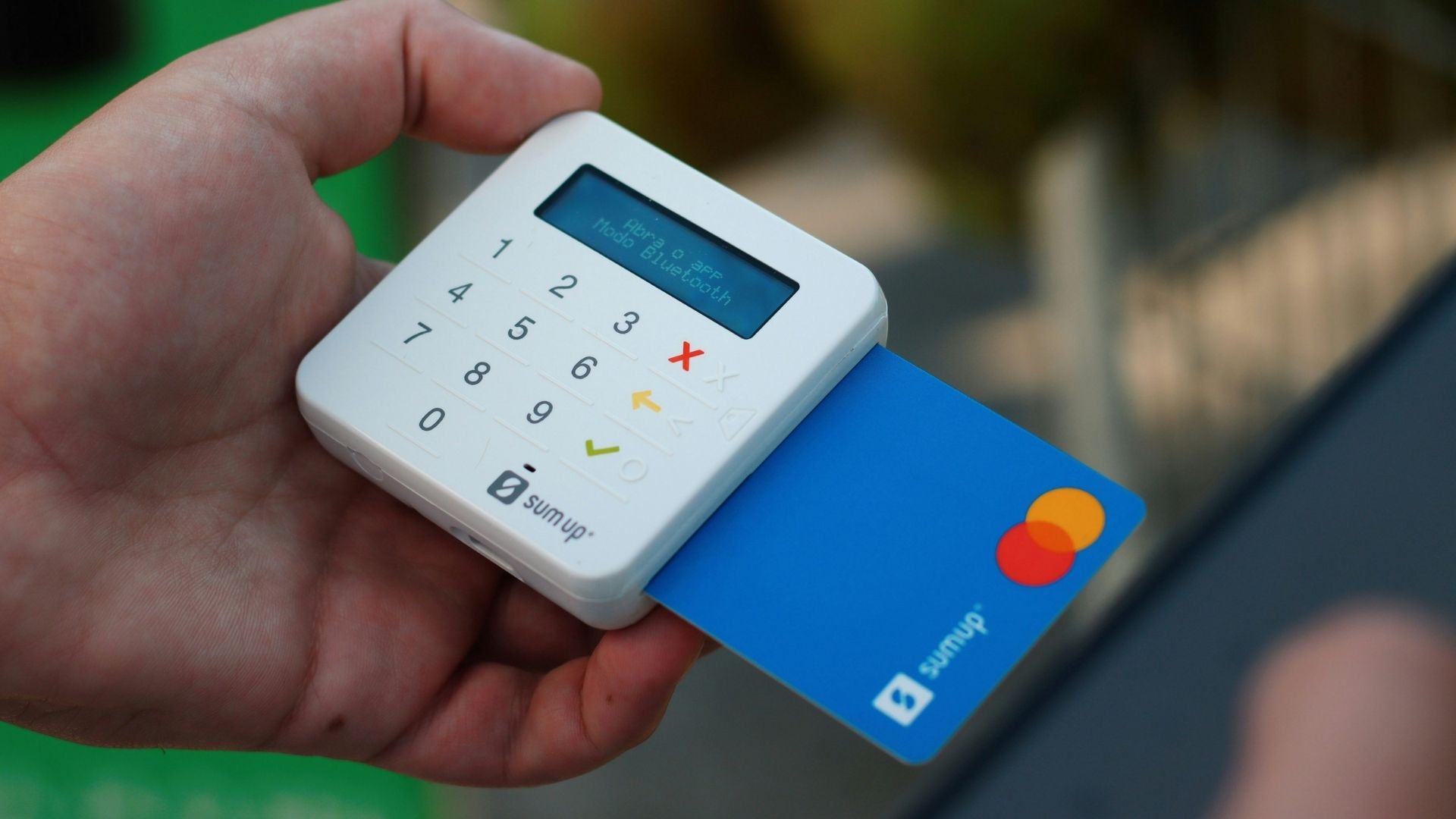 Person holding a credit card while using a cellphone