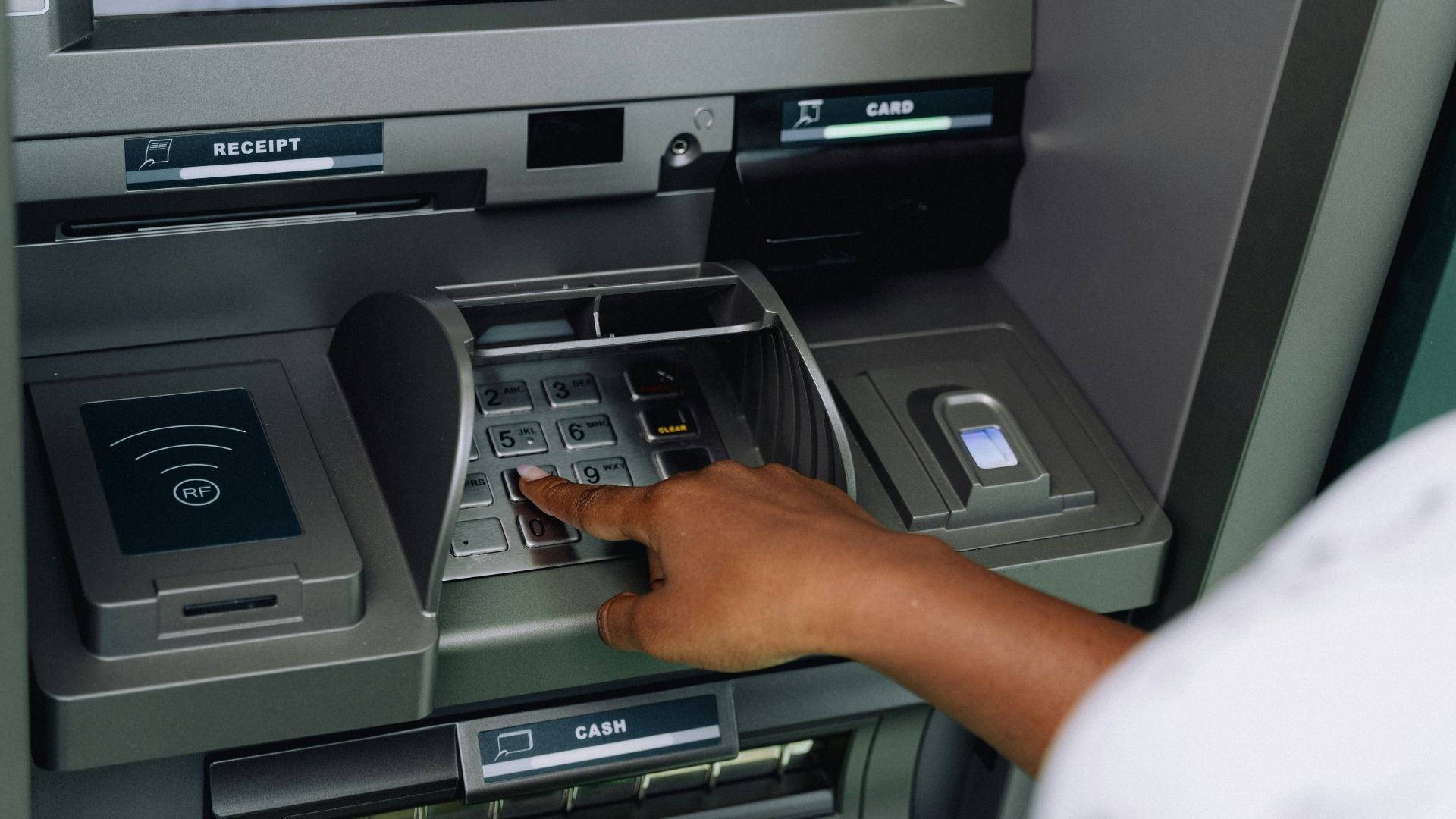 Person using an ATM to withdraw or deposit money
