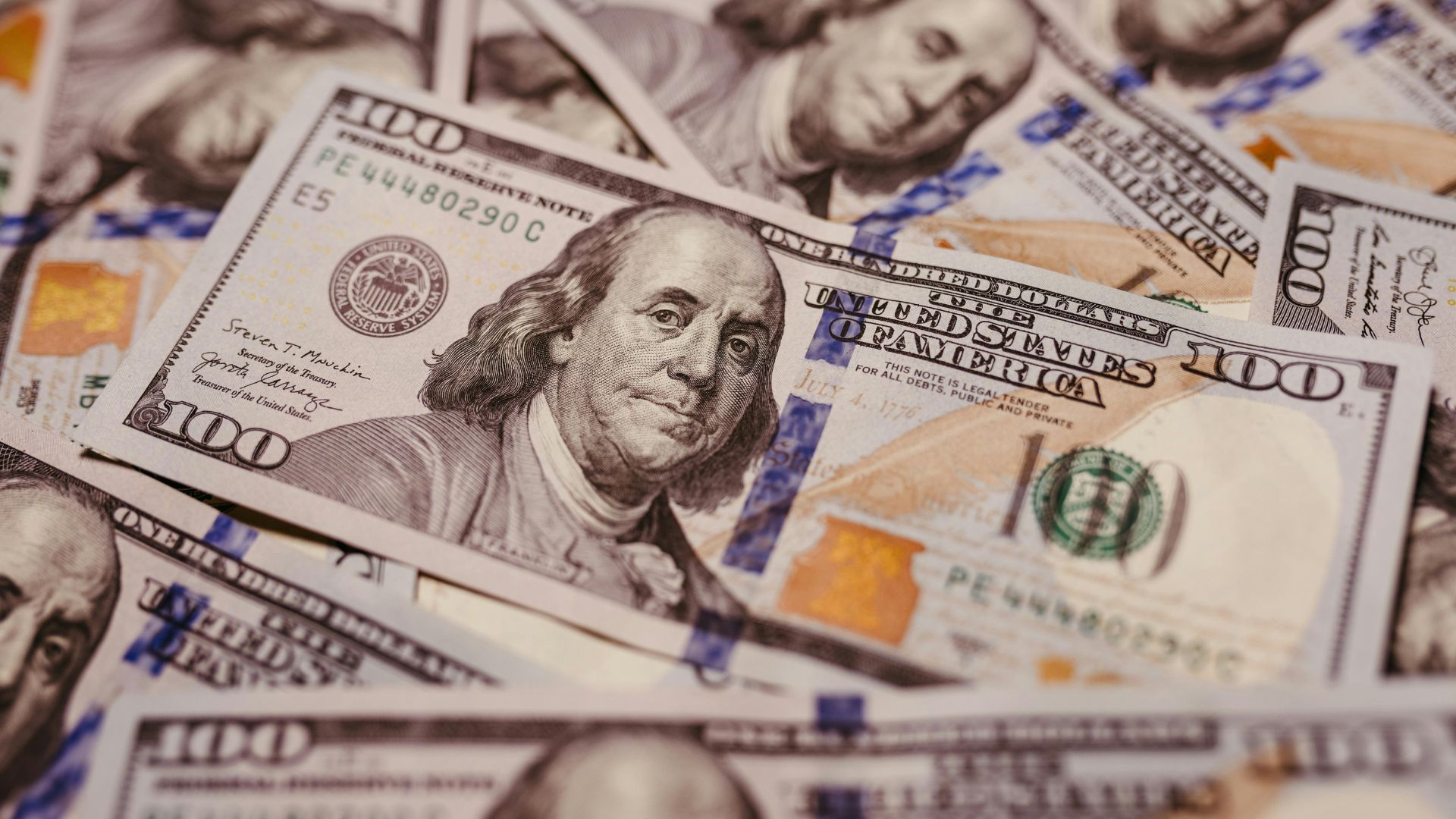 Close-up view of dollar bills spread out on a surface